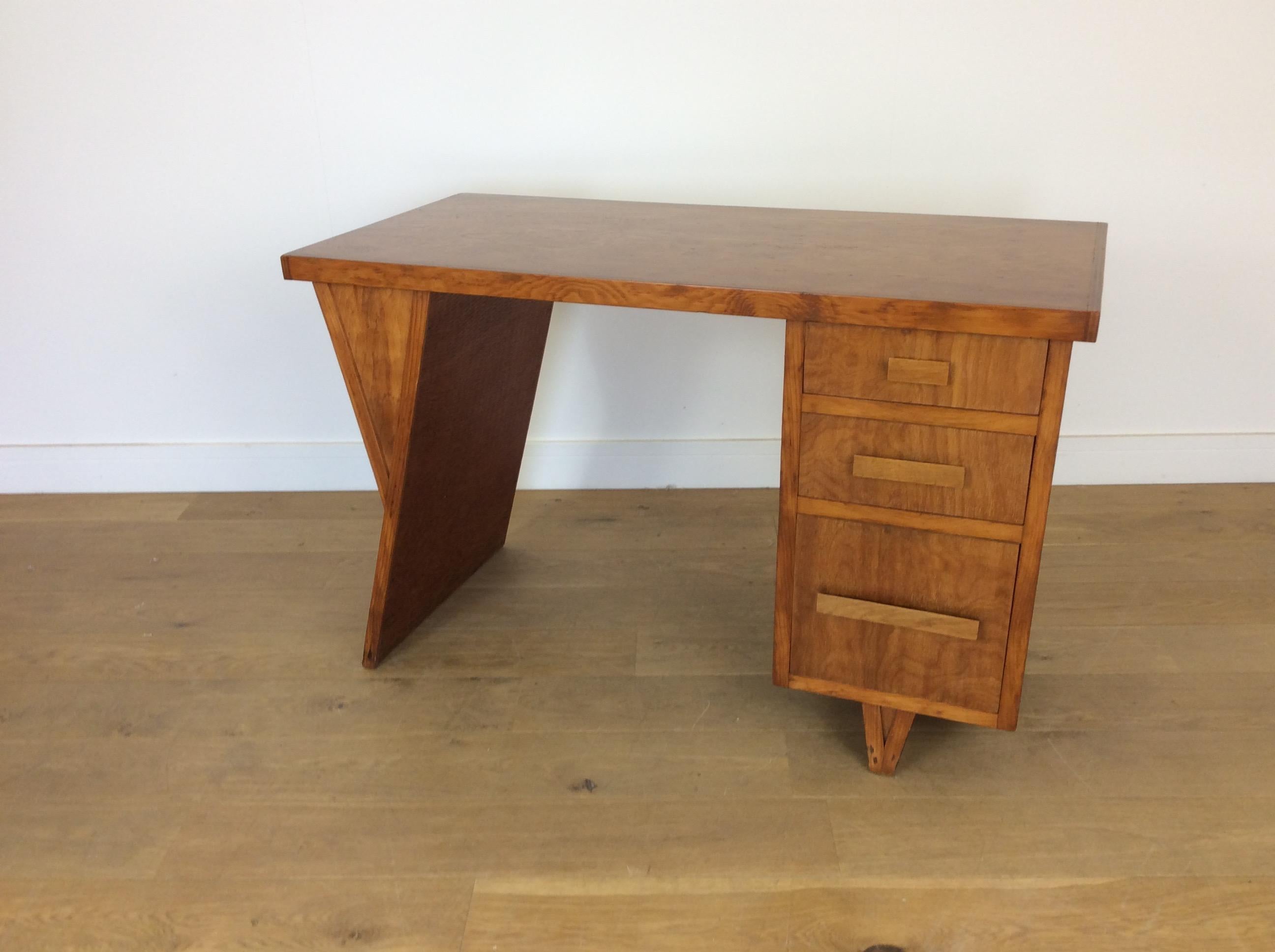 Unusual and rare midcentury textured ply desk.
At the moment this is unattributed, but a very interesting desk with loads of style.
Bank of three drawers to the right raised on a V support, the left with a panelled y support with this intriguing