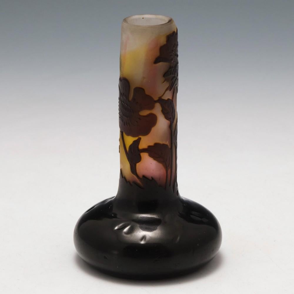 Heading :  A Galle Cameo Glass Vase
Date : 1906-1914
Origin : Nancy, France
Bowl Features A solid deep purple base evolving into a cameo cut flower leaf design, the neck internally streaked in pink, yellow and clear
Marks : Galle ,the epsilon