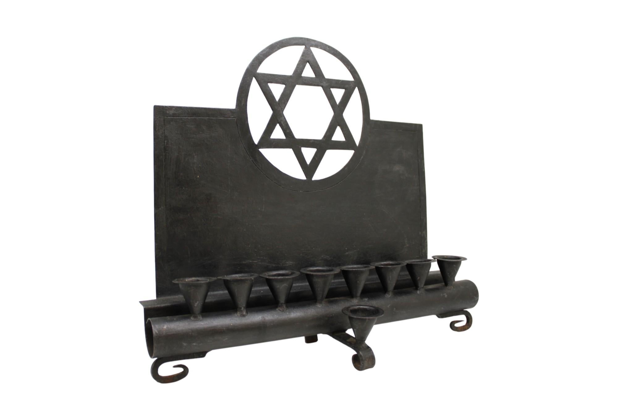 This rare and striking Modernist iron Hanukkah lamp, crafted in Germany circa 1930, is a powerful reflection of early 20th-century Jewish design sensibilities—fusing tradition with the sleek, industrial aesthetics of the Bauhaus and modernist
