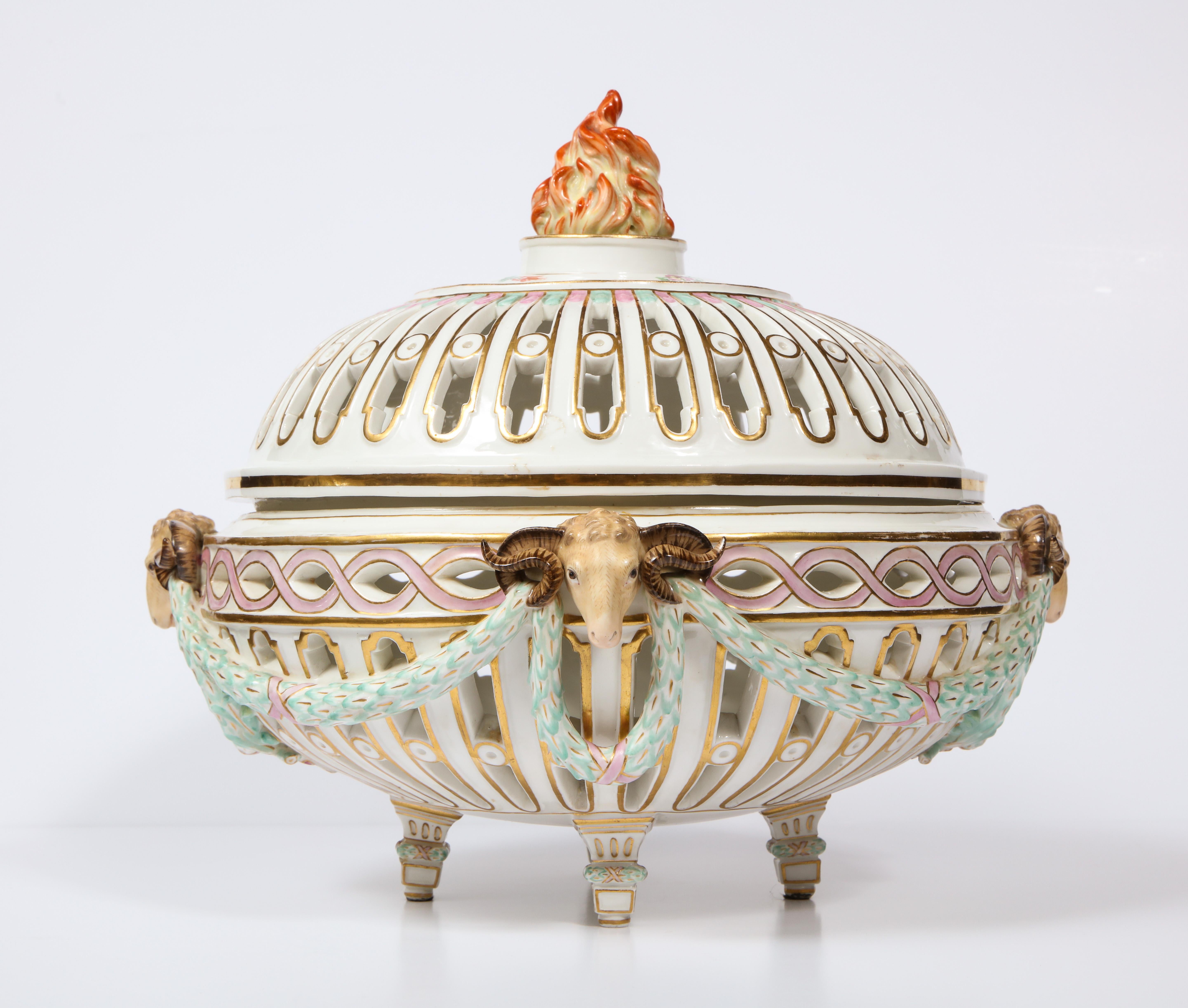 A large, beautiful, and rare 19th century neoclassical reticulated Meissen centerpiece with open filigree, rams heads, flaming finial, and love bird cartouches. This exquisite Meissen centerpiece was made in arguably the height of Meissen Porcelain