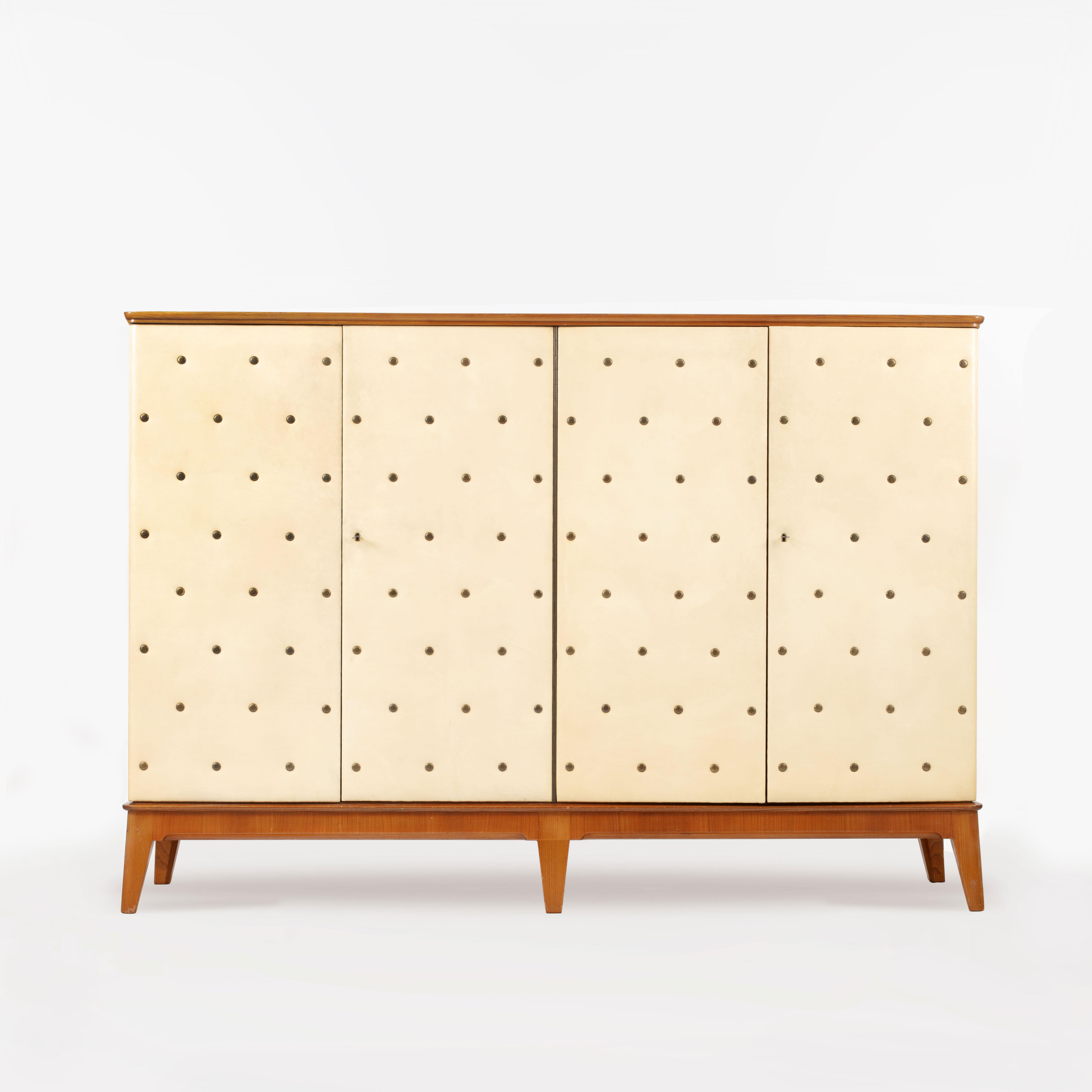 A rare, substantial Otto Schulz Cabinet, made by Boet, Sweden 1930s / 40s. Constructed from elm wood with the front and sides upholstered in cream faux leather. Seven loose shelves and four fixed drawers inside with original key present. Good