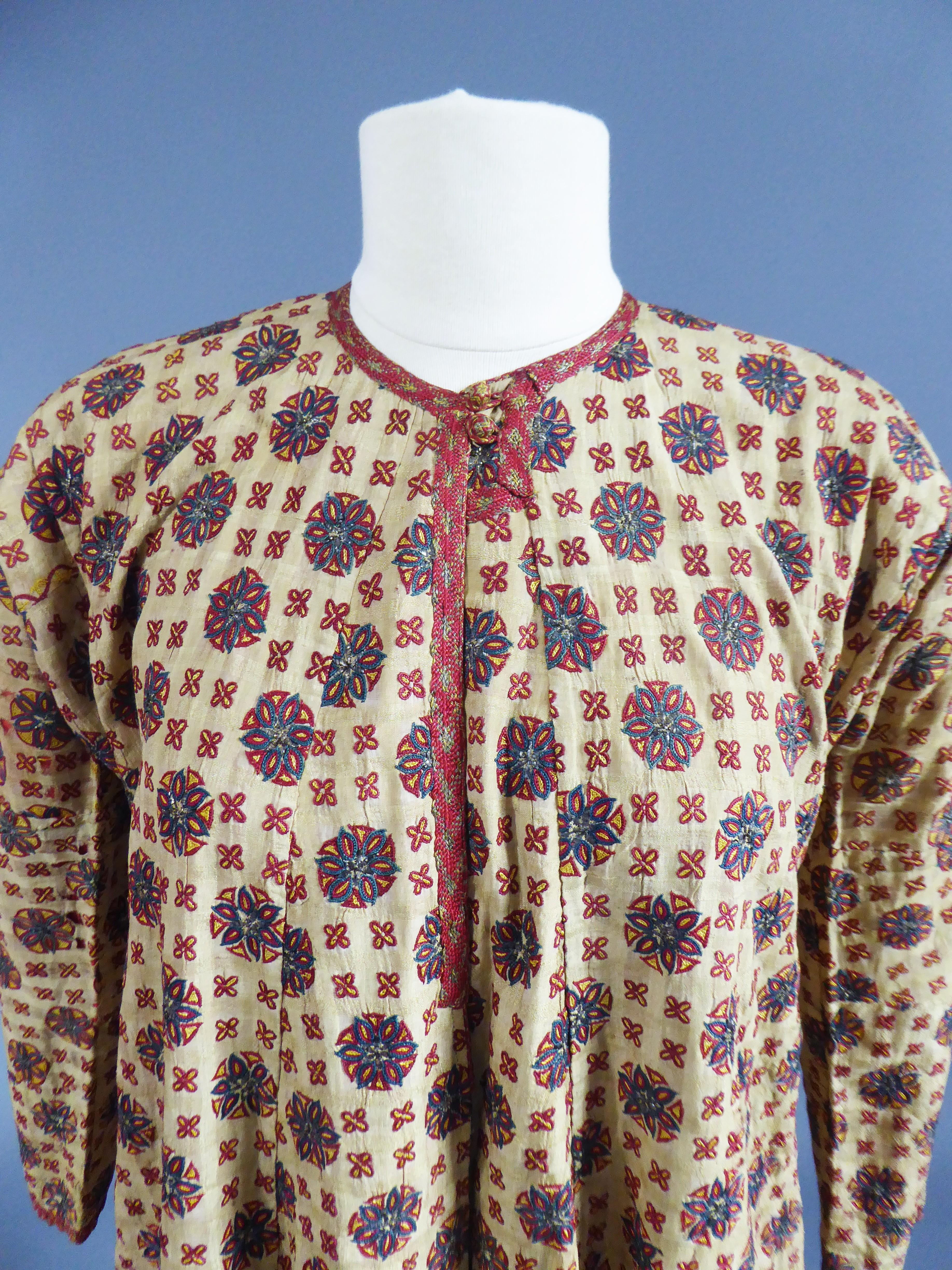 Late 18th or early 19th century
Ottoman Empire
Astonishing and very early banyan, kaftan or ottoman coat dating from the late eighteenth century. Raw silk background with woven check (Indian origin), Very finely embroidered wheels / suns with indigo