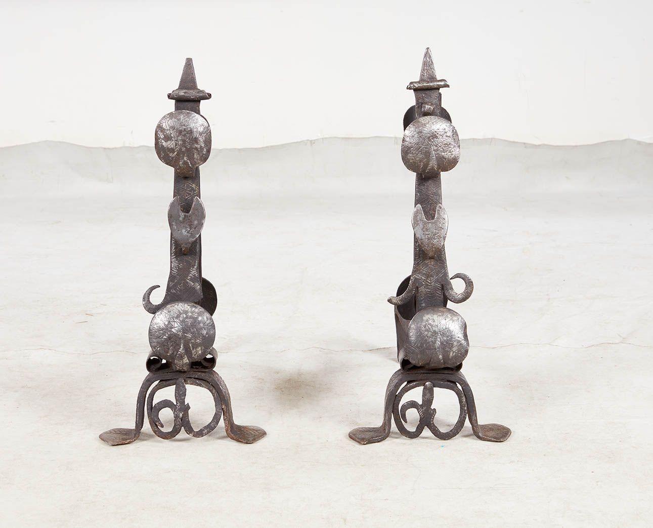 Rare pair of 16th century wrought and etched iron andirons, probably Portuguese, having spiked finials over scallop and crescent-moon shaped spit supports with Moorish inspired geometric etching, standing on chevron etched scrolled feet.