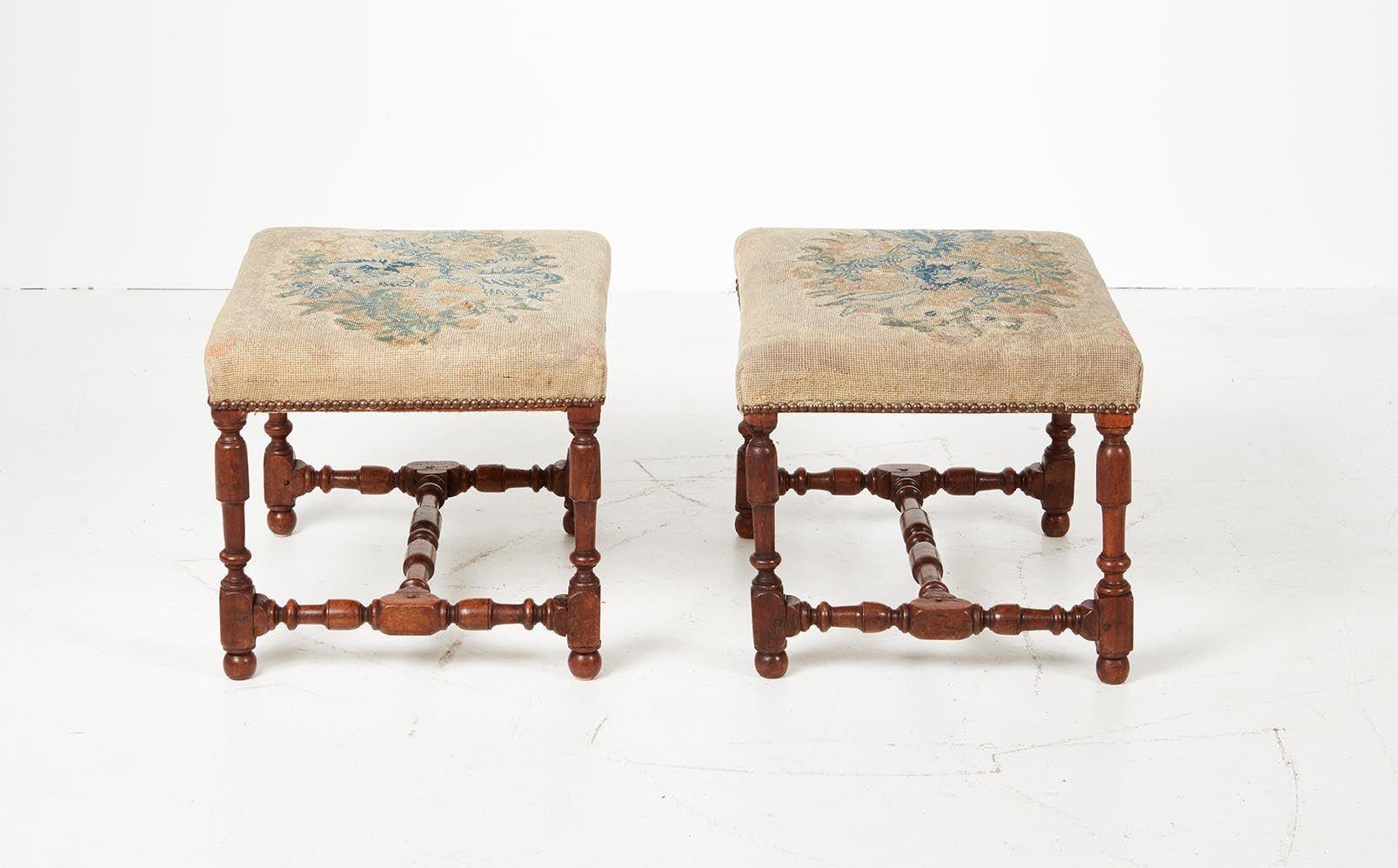 Rare pair of late 17th century Italian baroque walnut benches, the needlework upholstered seat over turned legs joined by similarly turned stretchers, possessing good nutty color and patination.