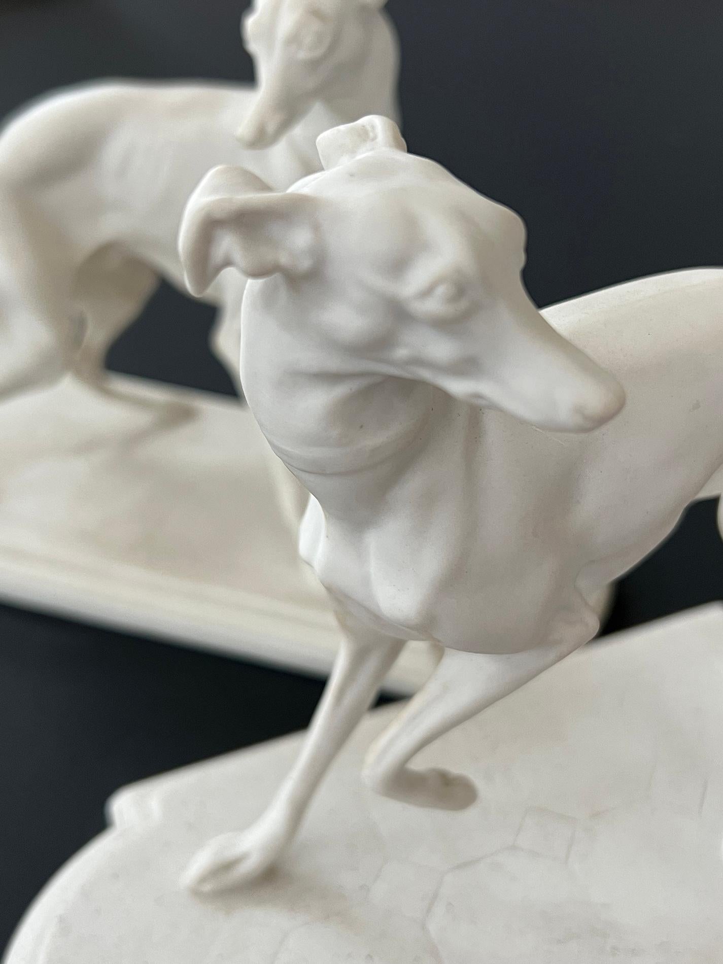 this rare pair of bisque porcelain whippet figurines from Boehm Studios was commissioned by President Dwight Eisenhower in 1954; each unique statue, one male and one female in an alert standing position with heads turned and ears pricked; with