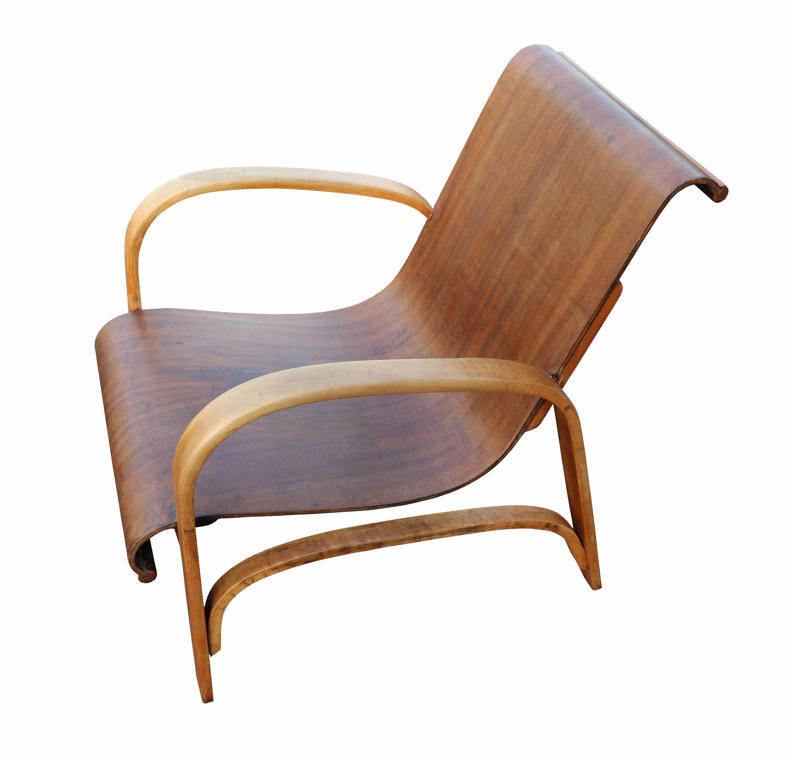 A rare and special pair of armchairs, made by Móveis Cimo.

Made at the end of 1940s, there are not many around nowadays as this design was produced in small quantities.
The seat and back rest are made with a single sheet of curved Imbúia plywood