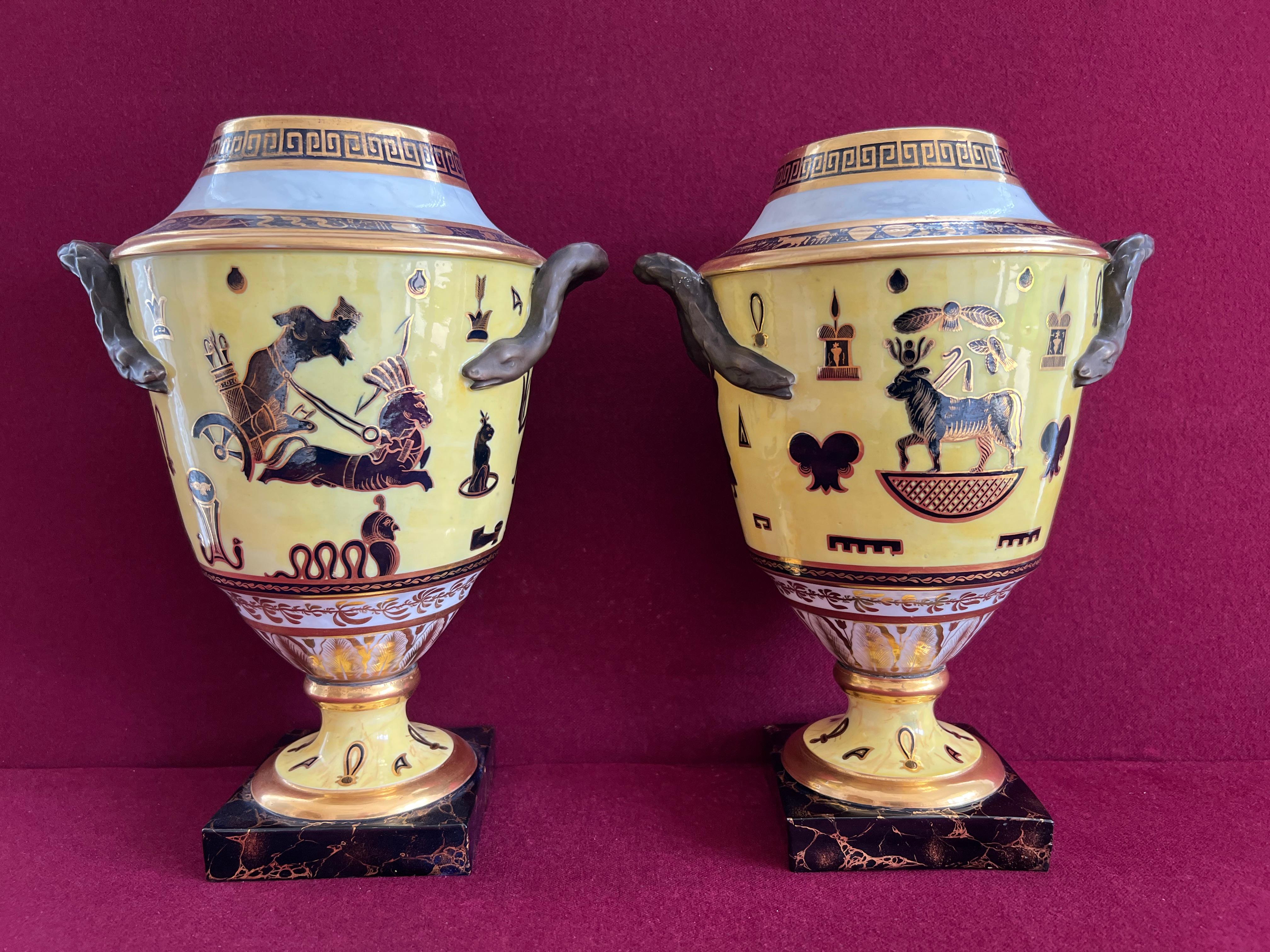 A rare pair of Derby porcelain Duesbury & Kean period yellow ground Egyptian revival vases c.1805-1810. Of tapering form with serpent handles, painted in black and gilt with Egyptian motifs, the shoulder with imitation hieroglyphs below a marbled