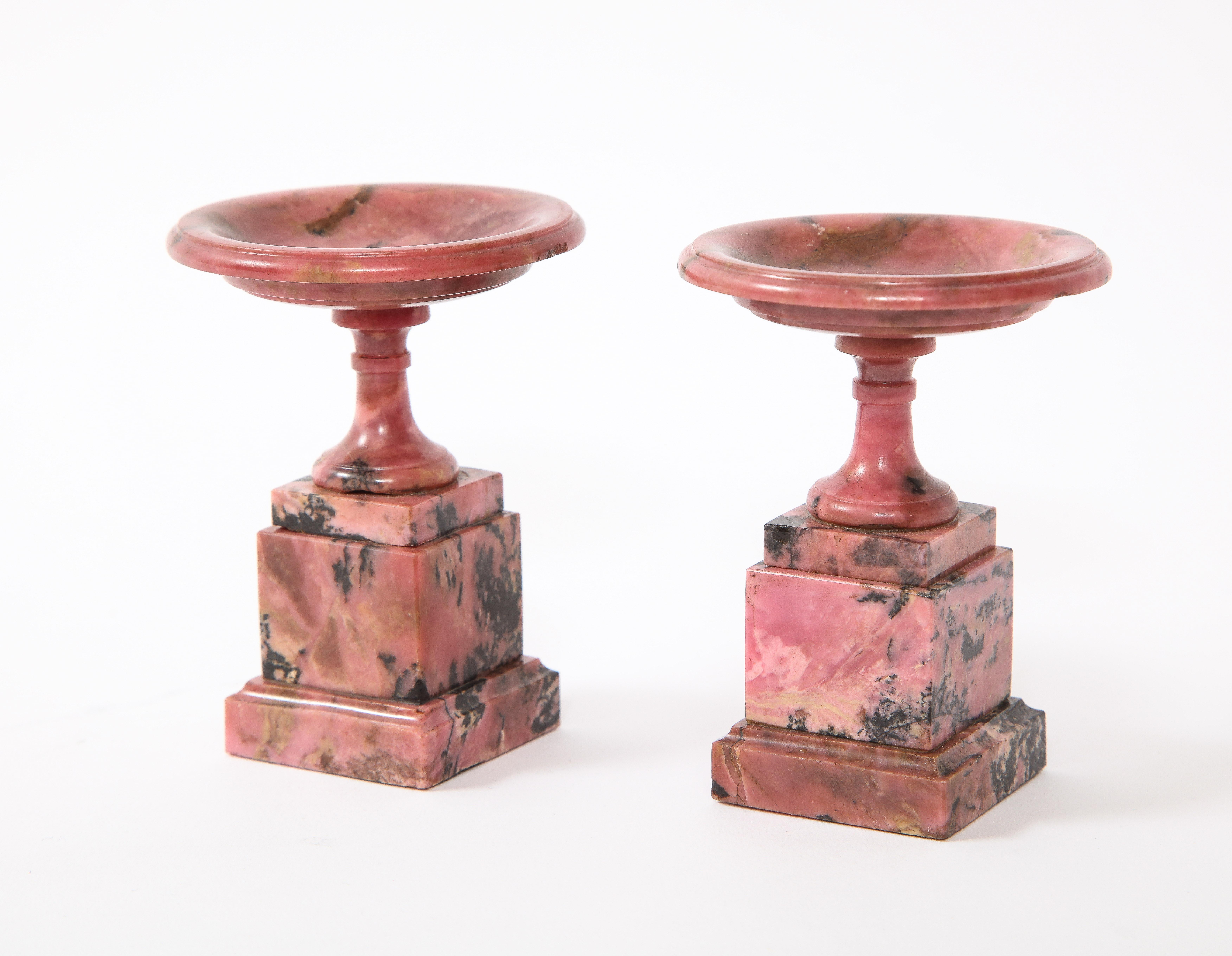 An absolutely gorgeous and rare pair of early 19th century Russian hand carved pink rhodonite Tazzas. The circular dish above a baluster-form socle, resting on a square stepped spreading pedestal. Rhodonite tazzas like these are extremely difficult
