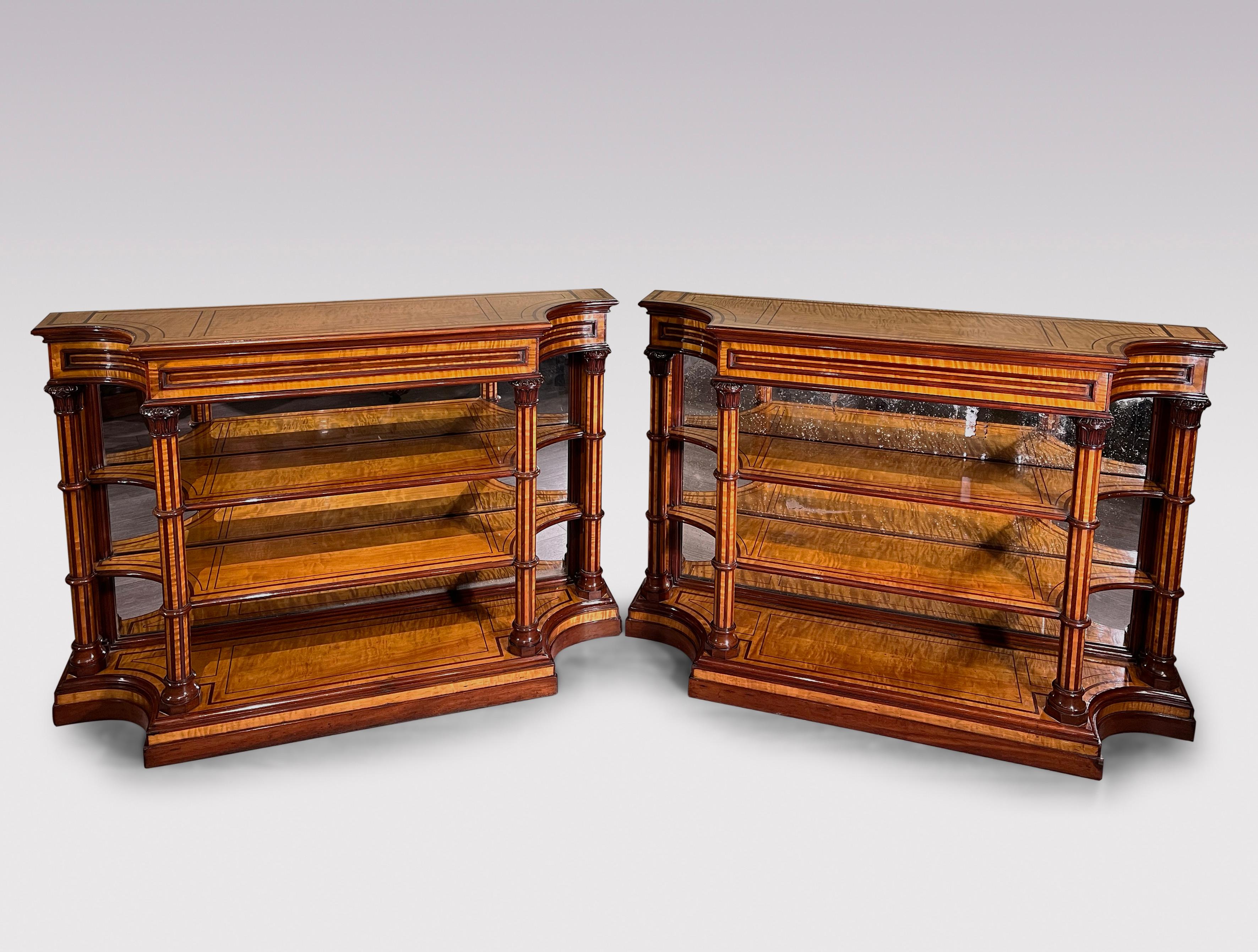 A fine and rare pair of early 19th Century Charles X period Satinwood open Bookshelves Purpleheart wood inlaid and banded throughout with Mahogany moulded edges. The Bookshelves, with concave corners and mirrored backs supported on turned and square