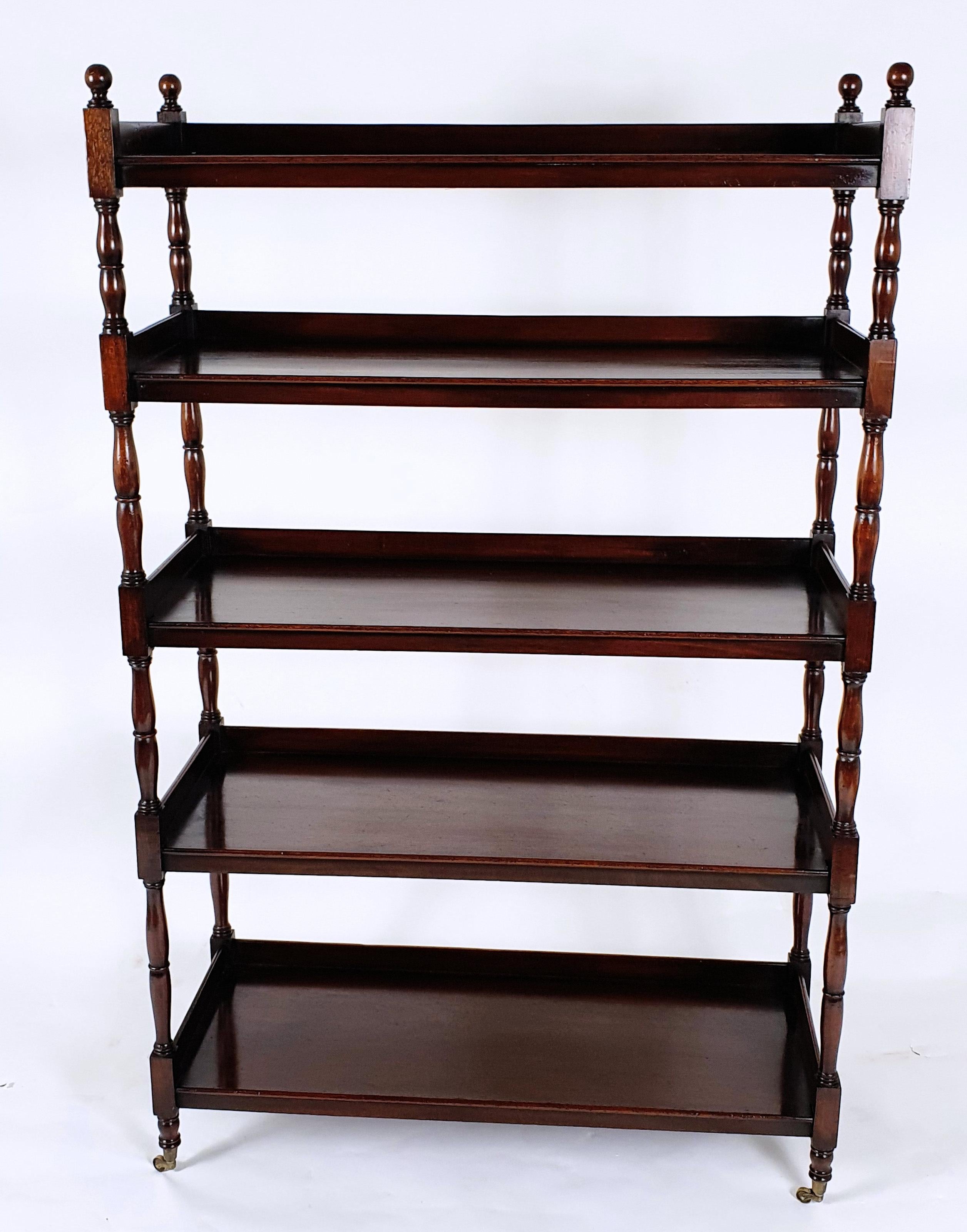 This superb and very rare pair of English Edwardian mahogany open bookcases feature 5 tiers with ¾ galleries. The shelves are united by slender turned columns and stand on brass castors. Each unit measures 36 ¼ in – 92 cm wide, 14 ½ in – 36.8 cm
