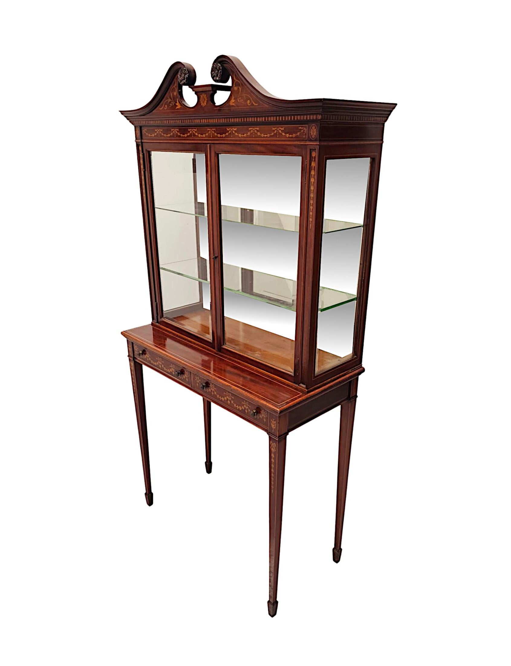 An extremely rare pair of finely figured, mahogany pier cabinets or bookcases in the manner of Edwards and Roberts.  This exceptional pair are finely carved with gorgeously rich patination and feature crossbanded panels, delicate line inlay and