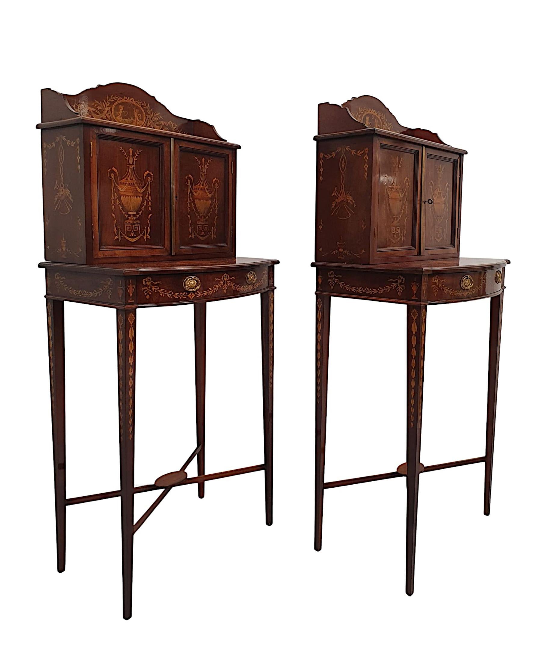 An extremely rare pair of exceptional mahogany side cabinets attributed to Edwards and Roberts, fabulously carved with gorgeously rich patination and grain. Beautifully detailed, crossbanded and inlaid with intricate marquetry work depicting