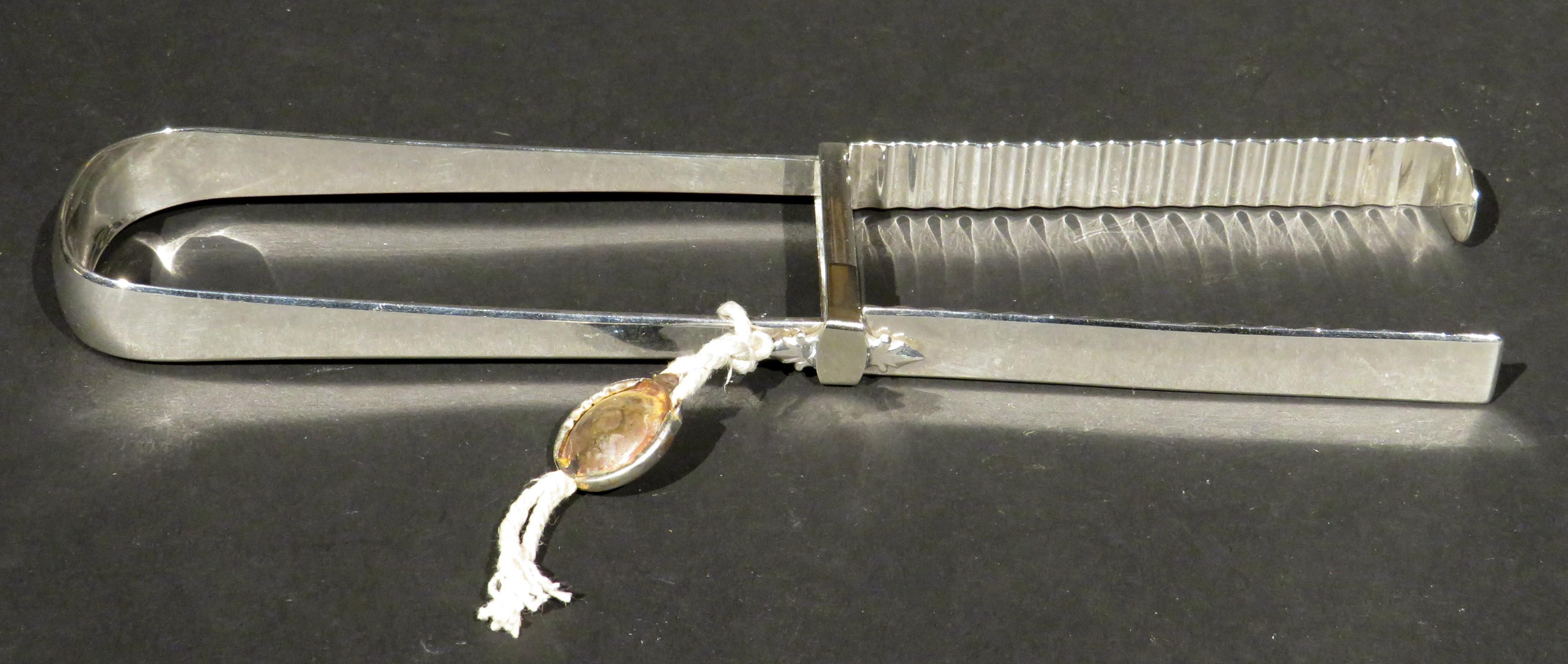 This fine and relatively rare pair of 18th century George III Period sterling silver asparagus tongs remains in fine overall condition, bearing London hallmarks and date marks for 1791, together with maker’s marks for Henry Chawner. The medallion