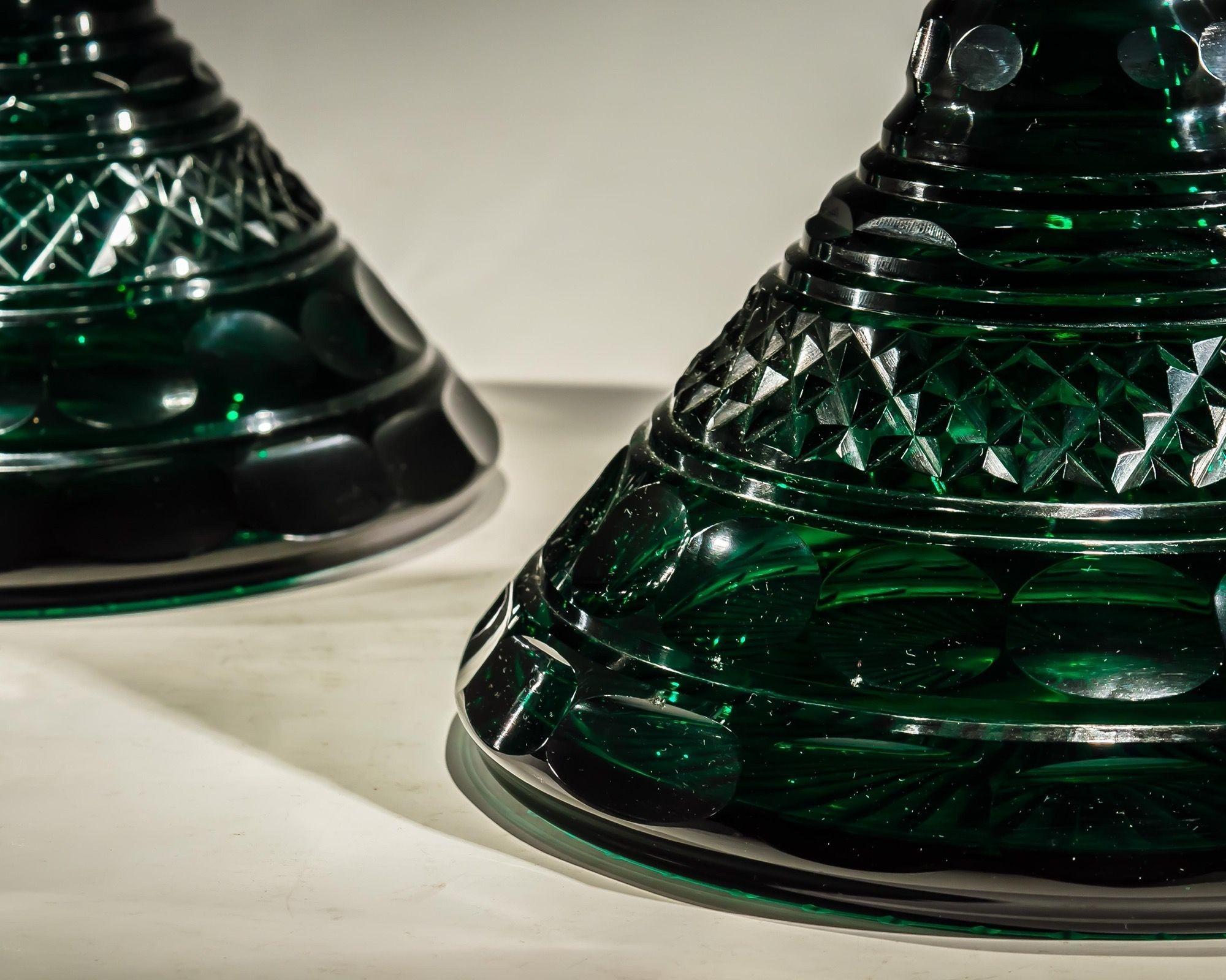 A rare pair of diamond, mitre and thumb cut emerald green ships decanters with mushroom stoppers.