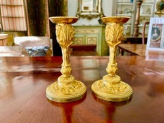 A rare pair of Louis XV gilt bronze candlesticks signed P. Gouthiere