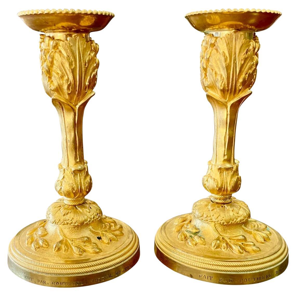A rare pair of Louis XV gilt bronze candlesticks signed P. Gouthiere