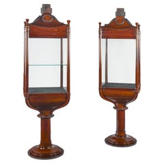 A rare pair of mahogany revolving nautically themed display cabinets