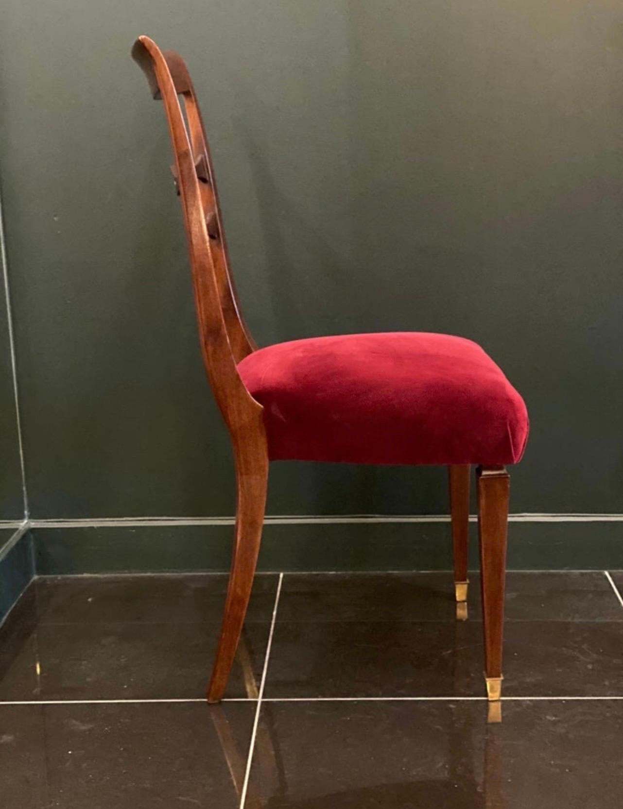 A beautiful pair of walnut dining chairs upholstered in red velvet with brass sabots by Paolo Buffa in collaboration with
Giuseppe Anzani.