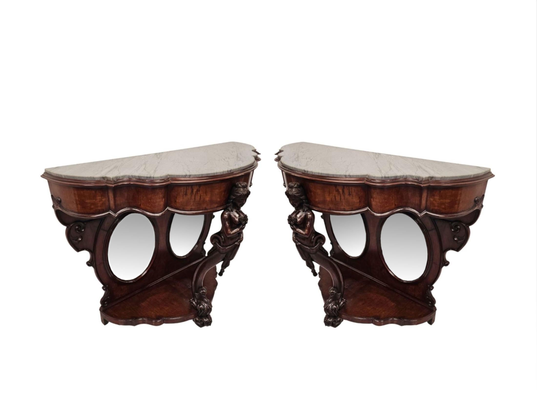 A very rare pair of finely figured mahogany marble top Country House console tables.  This impressive pair are of exceptional quality, tall proportions and finely hand carved with rich patination and grain.  The fabulous, moulded Grigio grey
