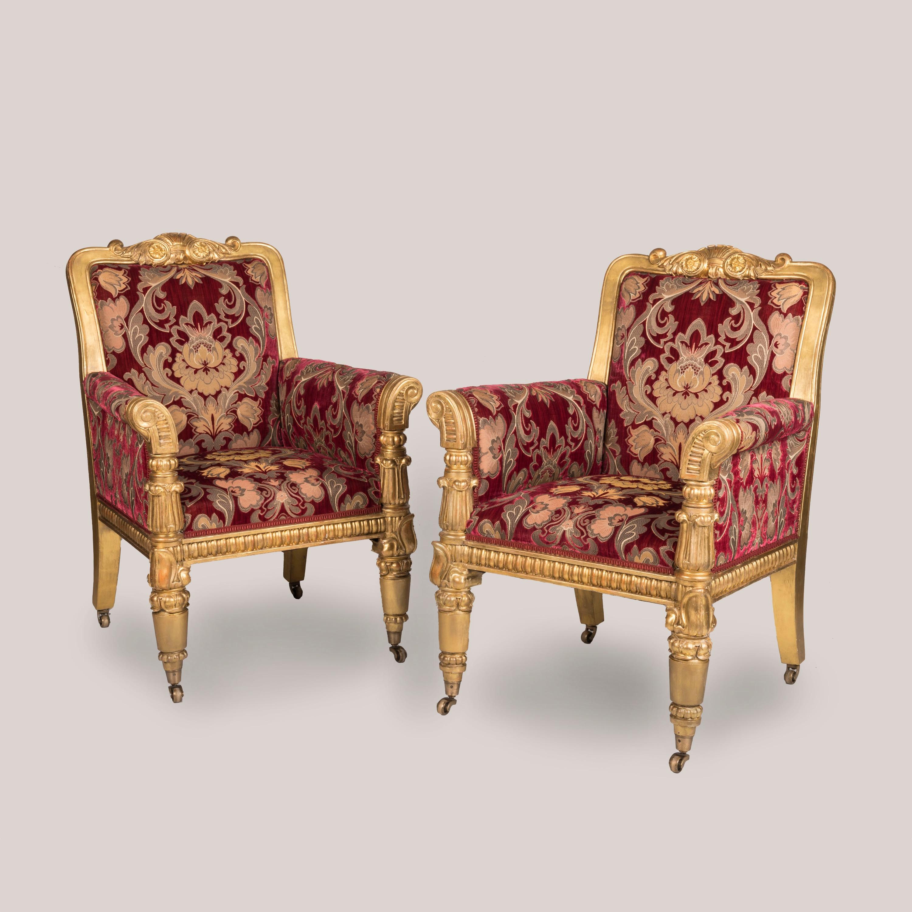 A Stately Pair of William IV Period Giltwood Armchairs

Of important size and carved with confidence, the pair of chairs on castor-shod turned front legs with stylised foliate designs, sweeping scrolled armrests, padded seat and backrest within a