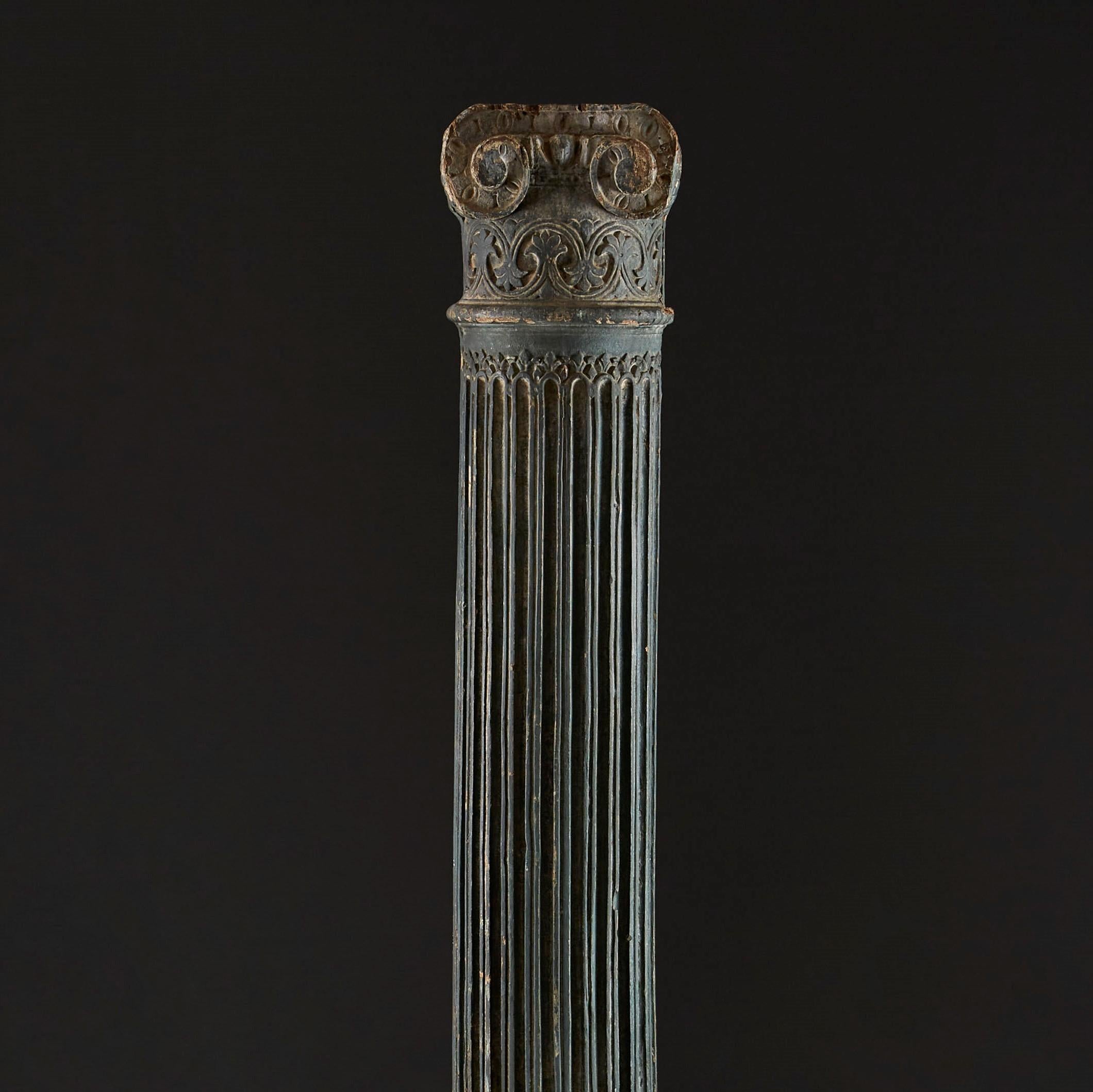 A rare Prussian blue carved wood and painted ionic column of large scale, with scrolled ionic capitol and fluted column, with original faded blue paintwork.