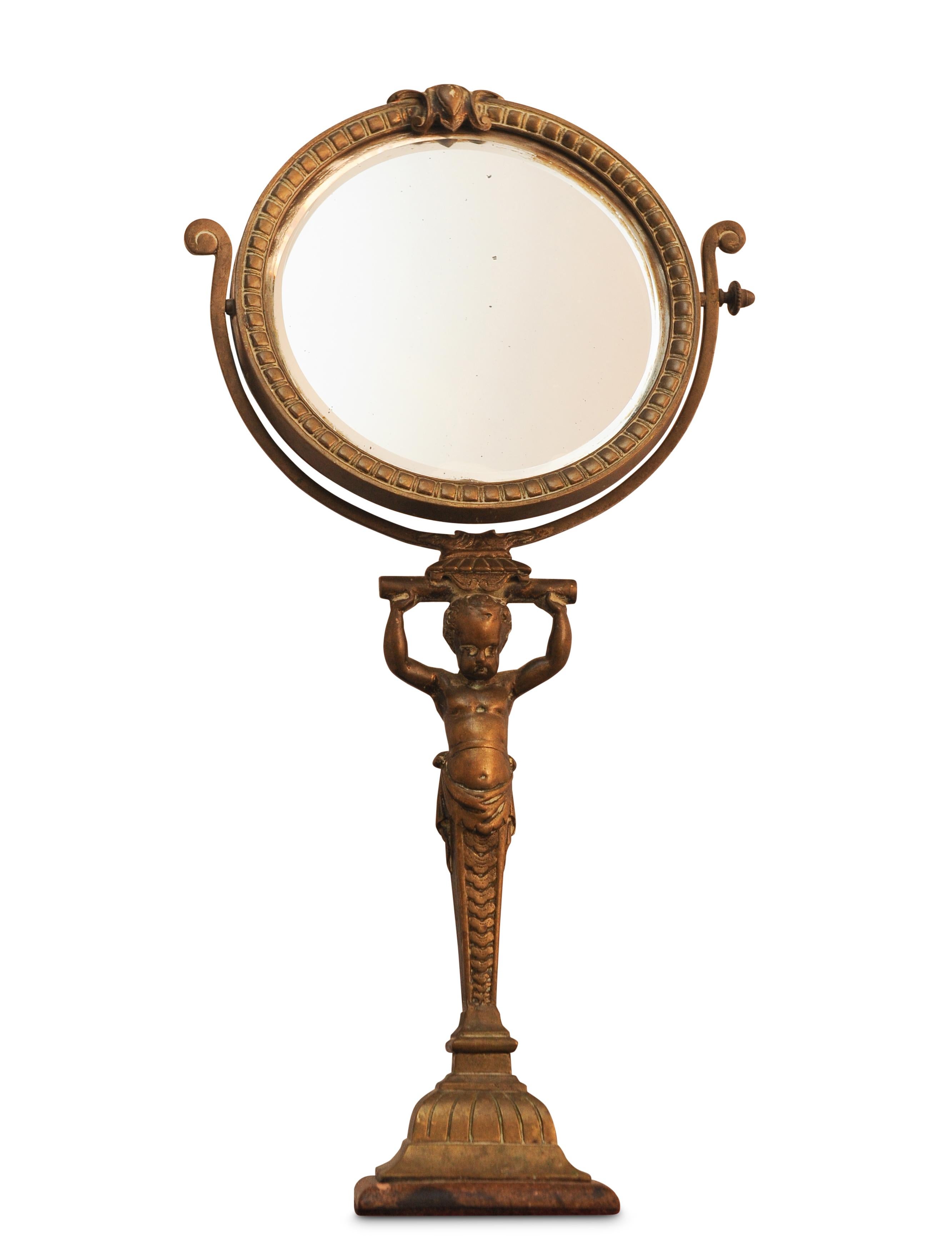 A Rare Regency Brass Revolving Bevelled Edge Vanity Mirror With Darted Frame & Decorative Cherub Column.
