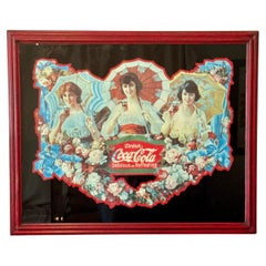 A rare reproduction of the Coca Cola umbrella girls in a rustic red frame