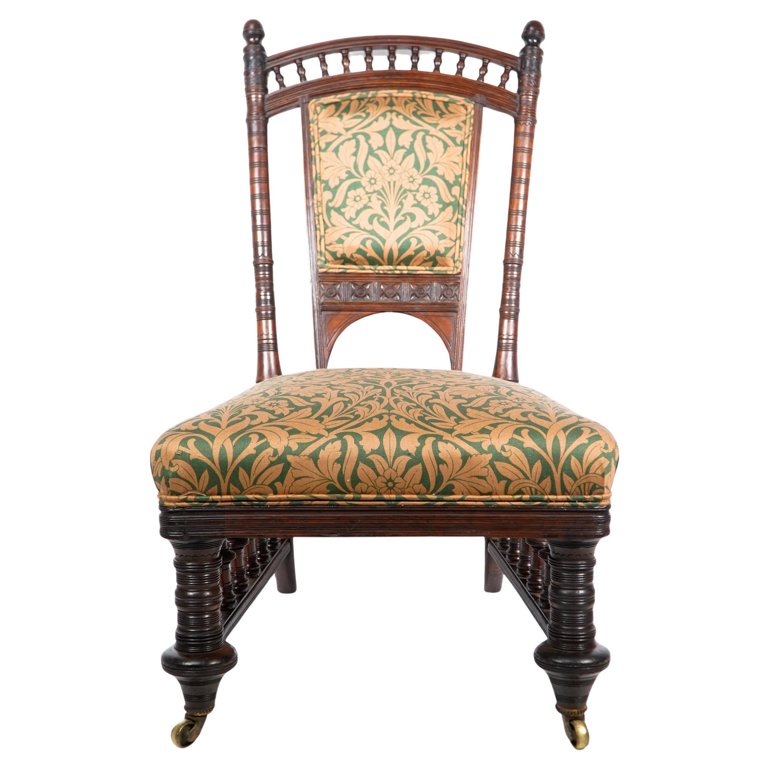 Collinson and Lock. A rare Aesthetic Movement Rosewood side chair with finely carved and turned details to the back supports with exagerated disc turned front legs and conforming side galleries below the seat. Professionally upholstered.
