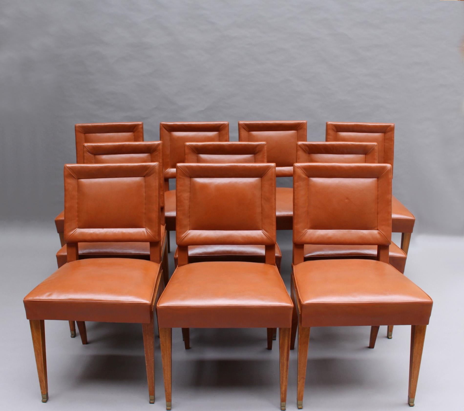 Jacques Quinet – An elegant and rare set of 10 mahogany dining chairs with original leather upholstery and Quinet's signature bronze 