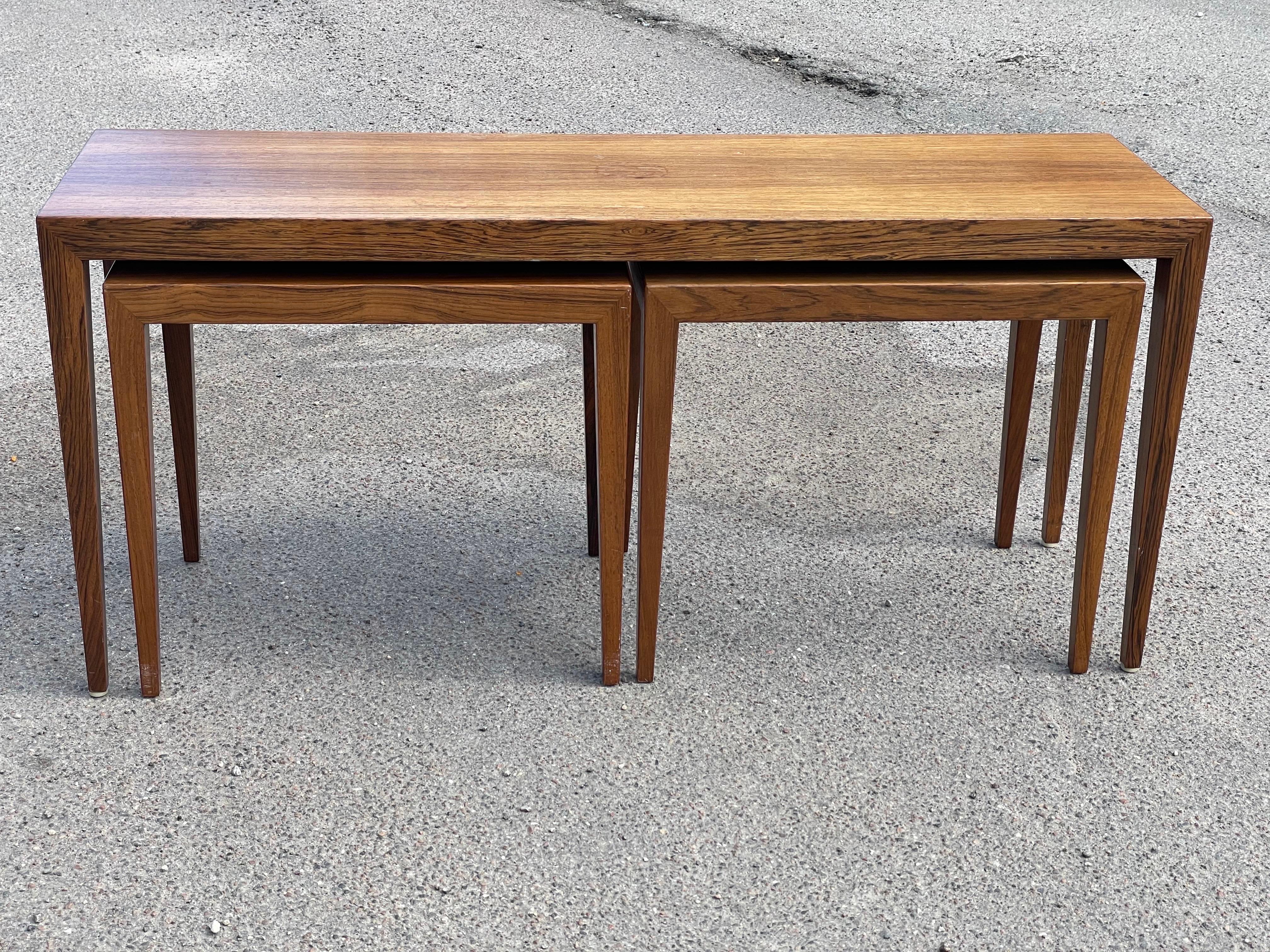 Introducing a rare gem - the Severin Hansen Mid-Century Modern Danish Nesting Tables Set, crafted in the 1960s. These exquisite tables are a testament to the impeccable craftsmanship of mid-century Danish design. The stunning dark wood finish and