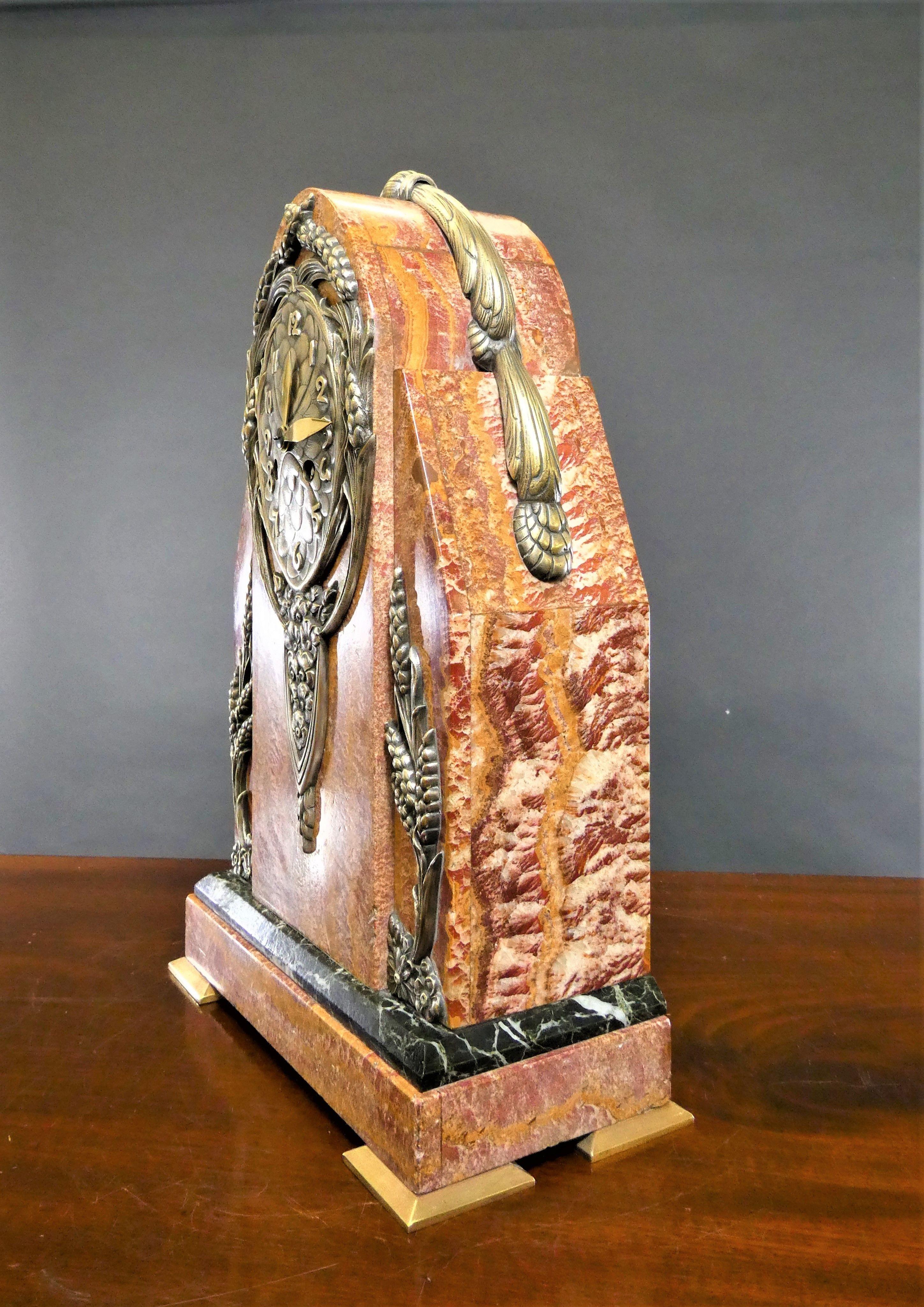 A rare skyscraper rouge marble Art Deco mantel clock.



A rare and unusual Art Deco Skyscraper mantel clock housed in a rouge marble case with exceptionally fine figuring with black marble plinth, applied pewter decoration featuring flowers and