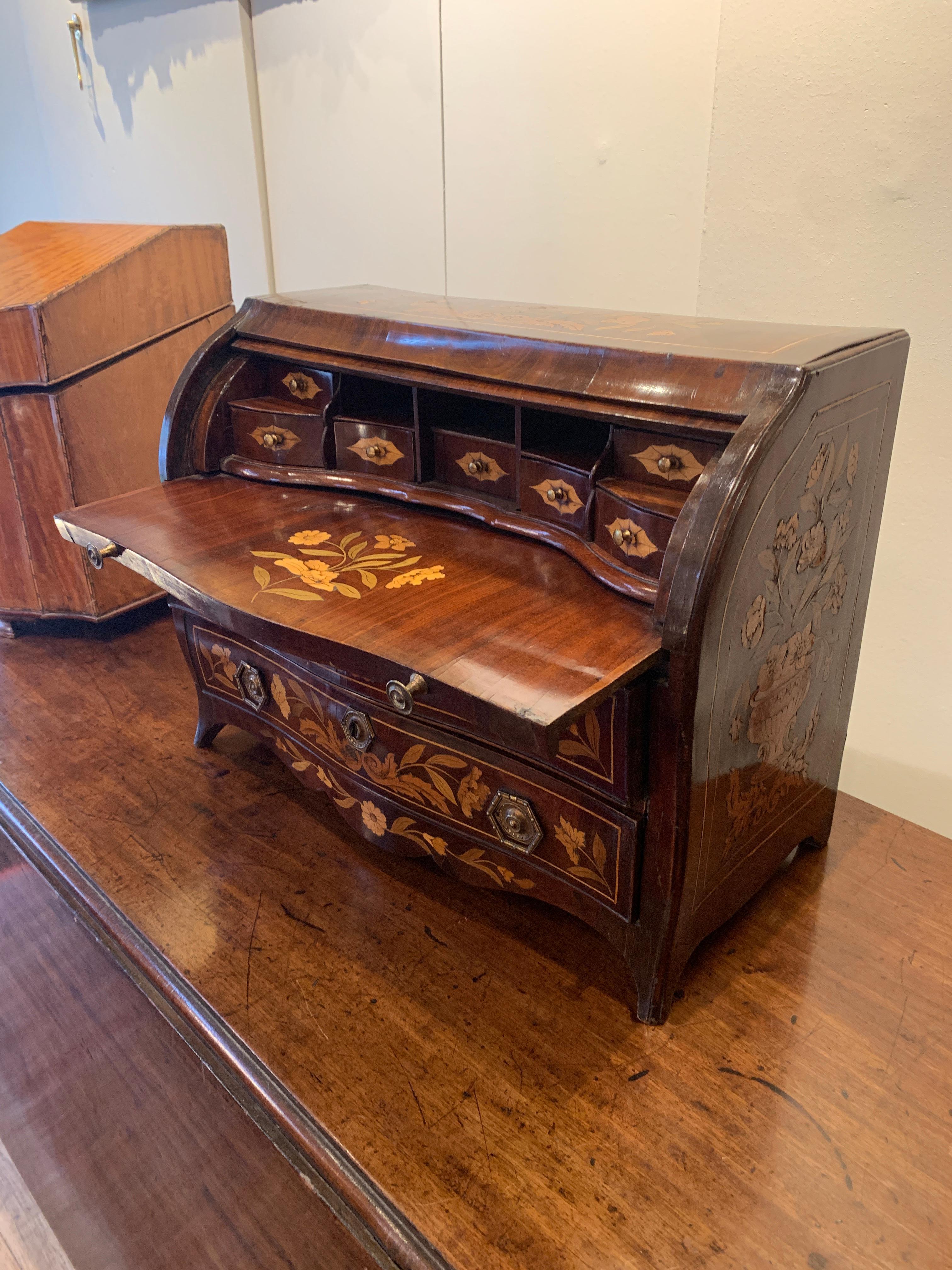 A rare, small marquetry cylinder bureau. Different fruit woods,
circa 1820

Measures: Height 37cm
Width 49cm
Depth 23cm
Price: £8,750.