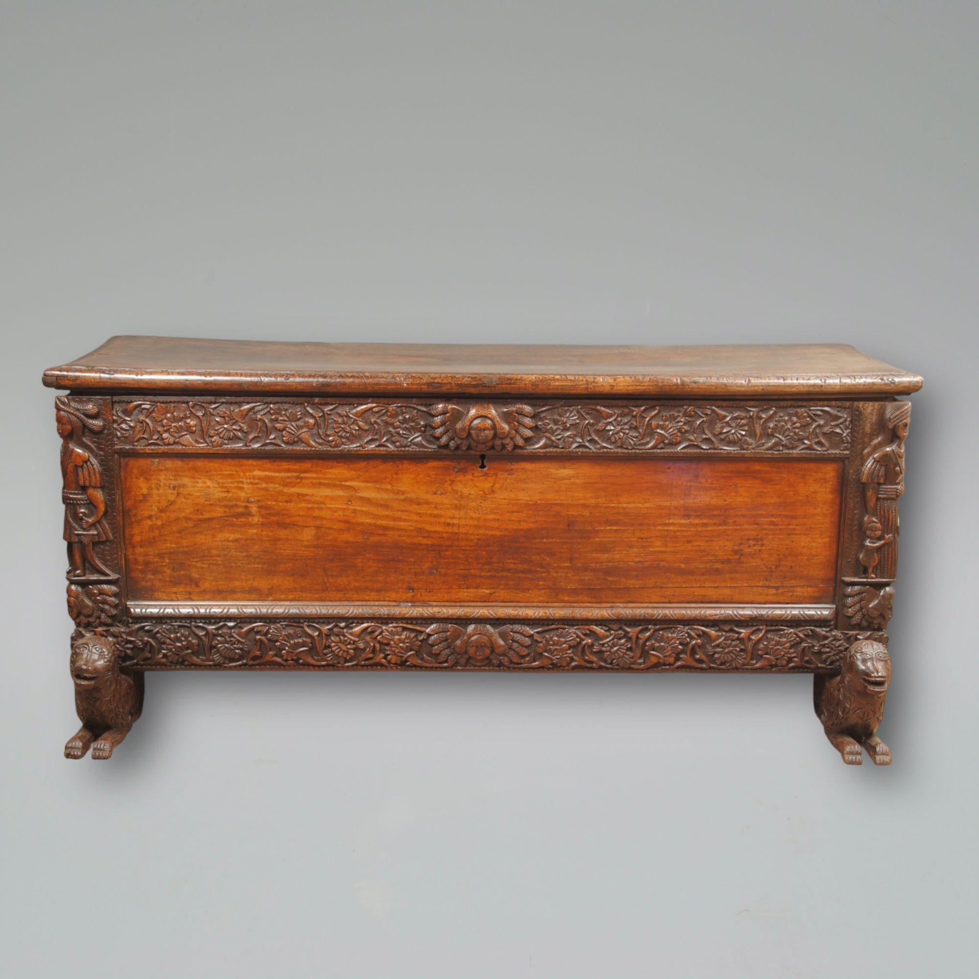 A 17th century carved South American hardwood coffer with caryatids to the sides showing stylized figures of Indians
Raised on carved recumbent animal feet.
Circa 1680