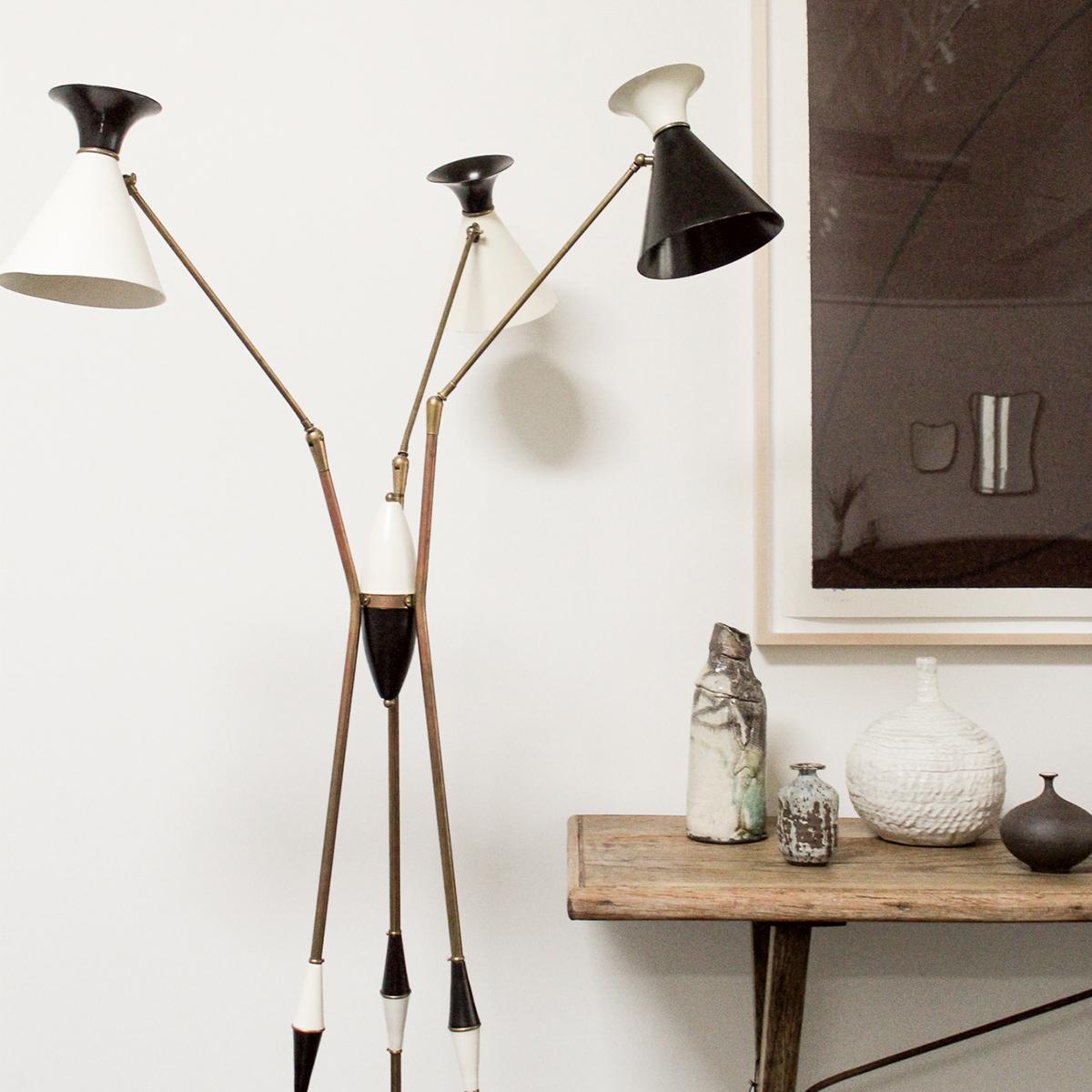 A rare Stilnovo black and off-white three light tripod floor lamp with moveable arms from the 1960’s. The fixture features three enamel shades has been rewired and restored by the Selby House. Each arm and lampshade is fully adjustable allowing the