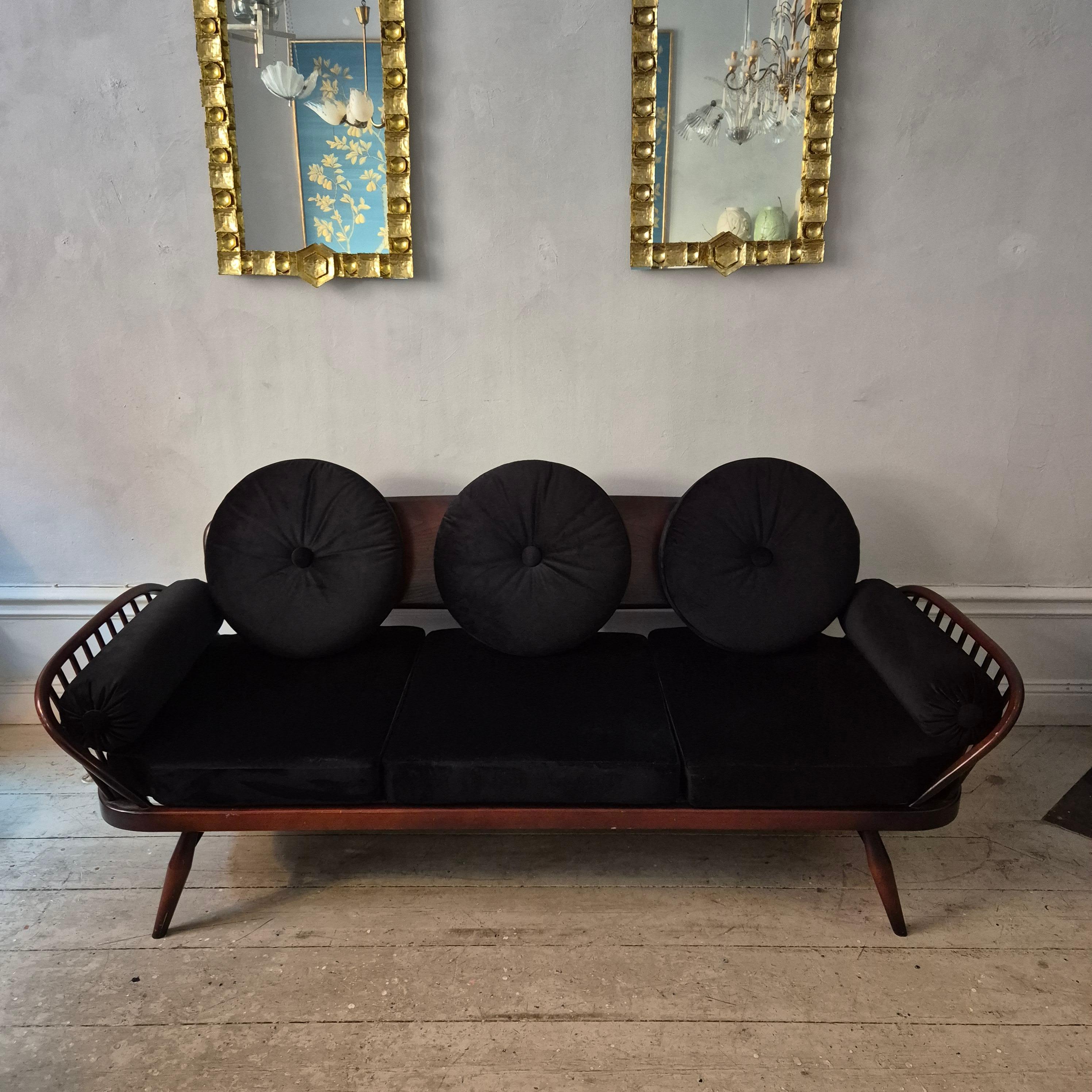 Sofa in stained ash, model Studio by italian designer Lucian Ercolani. This iconic sofa was designed in the mid 1950's and manufactured by the designers company Ercol in England. 

Re-upholstered in black velvet. Loose cushions. 
