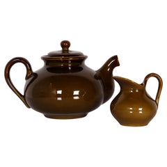 A rare tea set in dark green by Saint-Clément includes a teapot and a milk jug