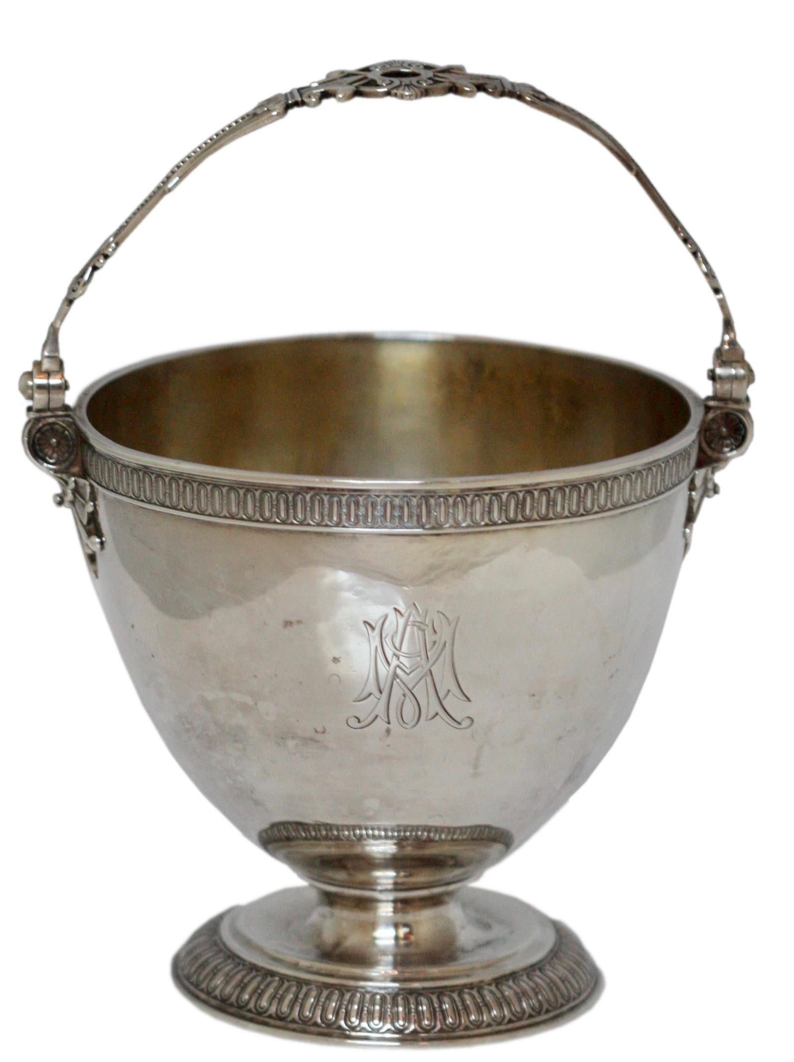 A rare Tiffany & Co. Sterling silver sugar bowl. 
American, 1870-1875.
Made for an International Exposition. 
Of basket shape with swing handle, engraved with a conjoined monogram with guilloche borders on a circular foot.
Diameter 4 1/2