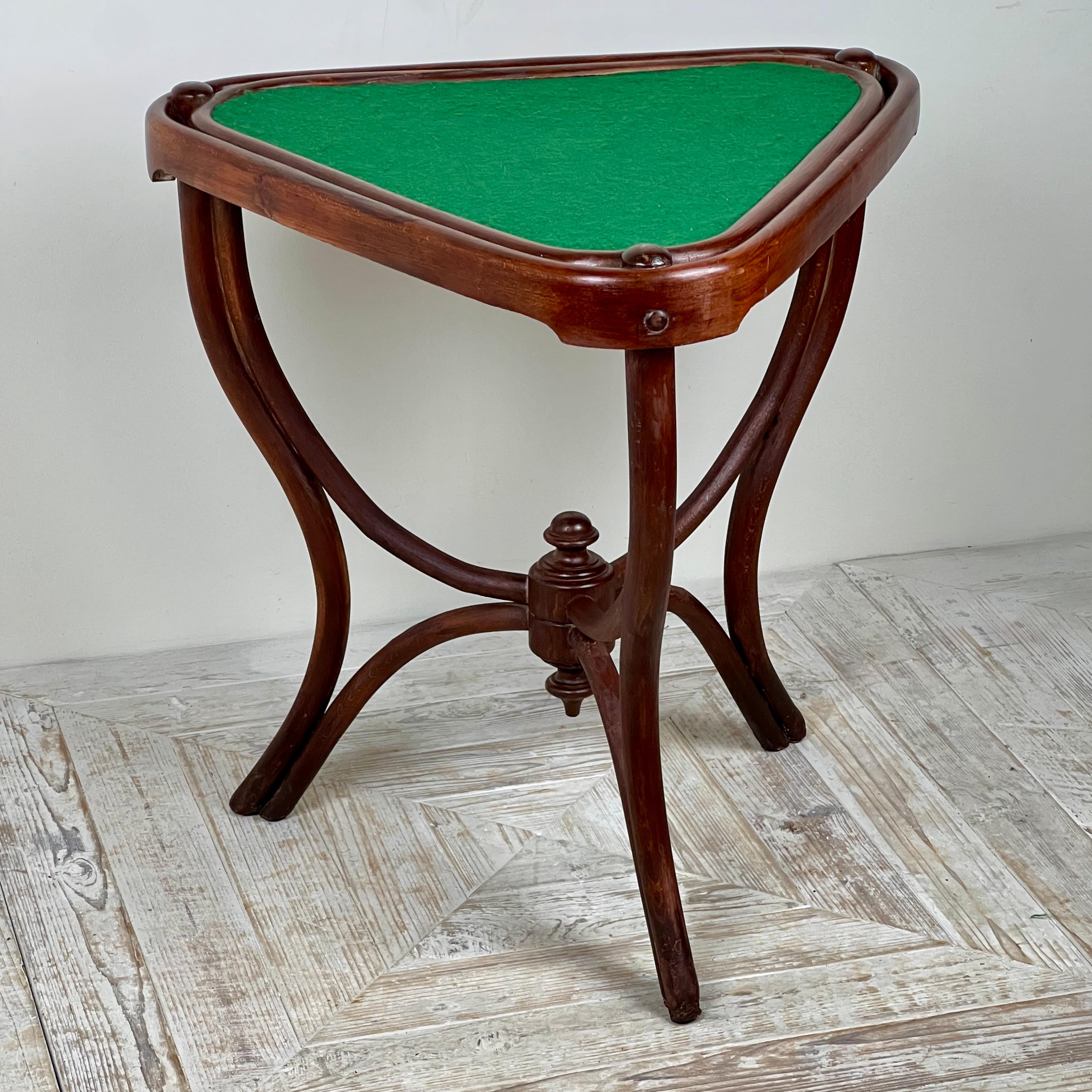 A Rare Triangular Thonet Bentwood Card Table, Circa 1900

A beautiful bentwood design featuring a triangular playing surface covered in green woollen baize. The table stands on elegantly formed sabre legs joined by a central stretcher with a