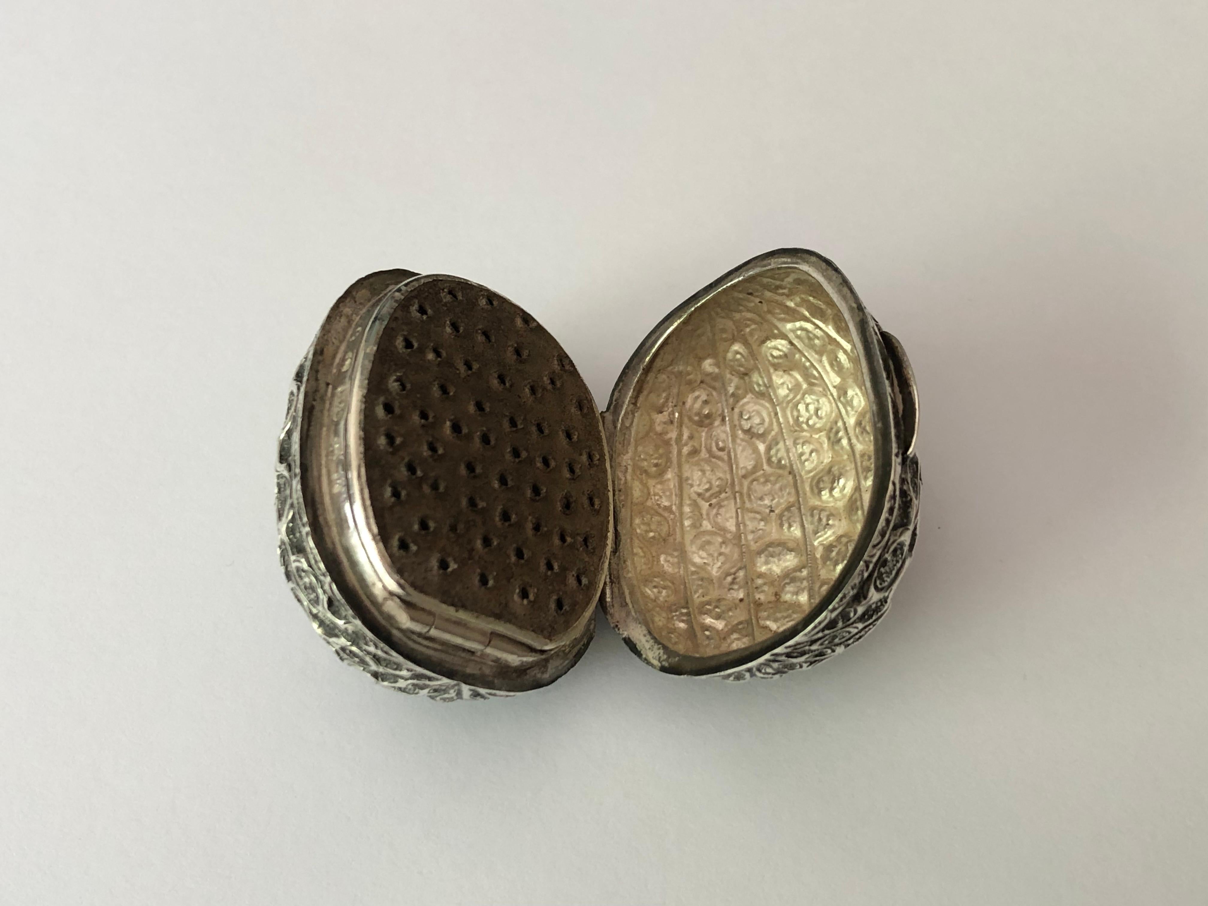 A rare Victorian silver naturalistic nutmeg grater, modelled in the form of a nutmeg/mace.
Hilliard and Thomason. Birmingham, 1859.

The hinged cover opens to reveal a blue steel rasp. The rasp in turn is hinged to reveal a compartment in which