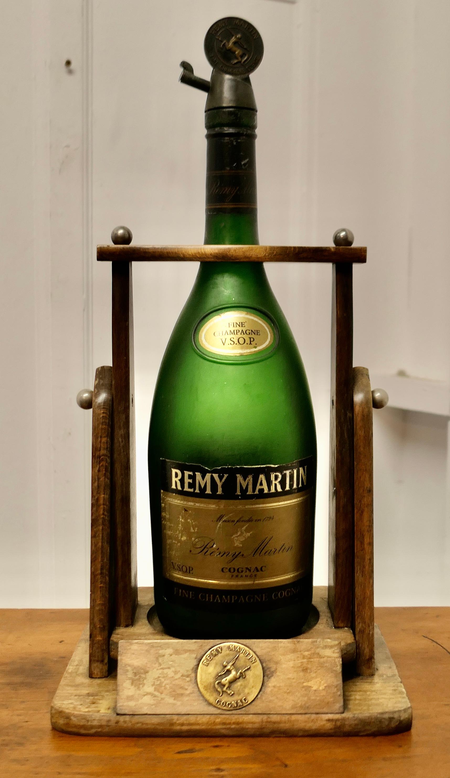A Rare Vintage Remy Martin 3 Litre Bottle with Original Cradle Pouring Stand

A Rare piece, this would have been used for “dégustation” of the fine Champagne Cognac V.S.O.P. The Jeroboam tilts easily and pours out one measure  
This is a great piece
