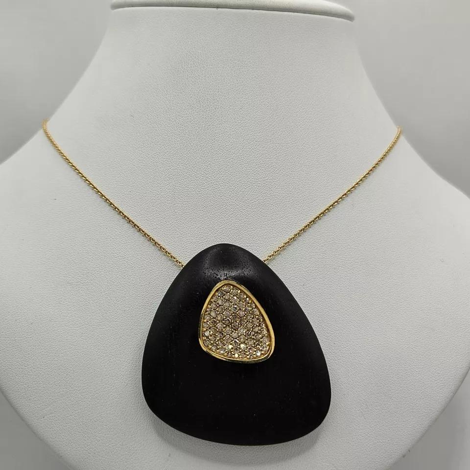 A Rare Roberto Coin 'Capri Plus' Ebony Wood & Diamond 18ct-18k Gold Necklace


A superb quality Capri Plus ball chain necklace featuring 0.80 carats of round brilliant cut diamonds and carved wood slide pendant and adjustable lobster clasp