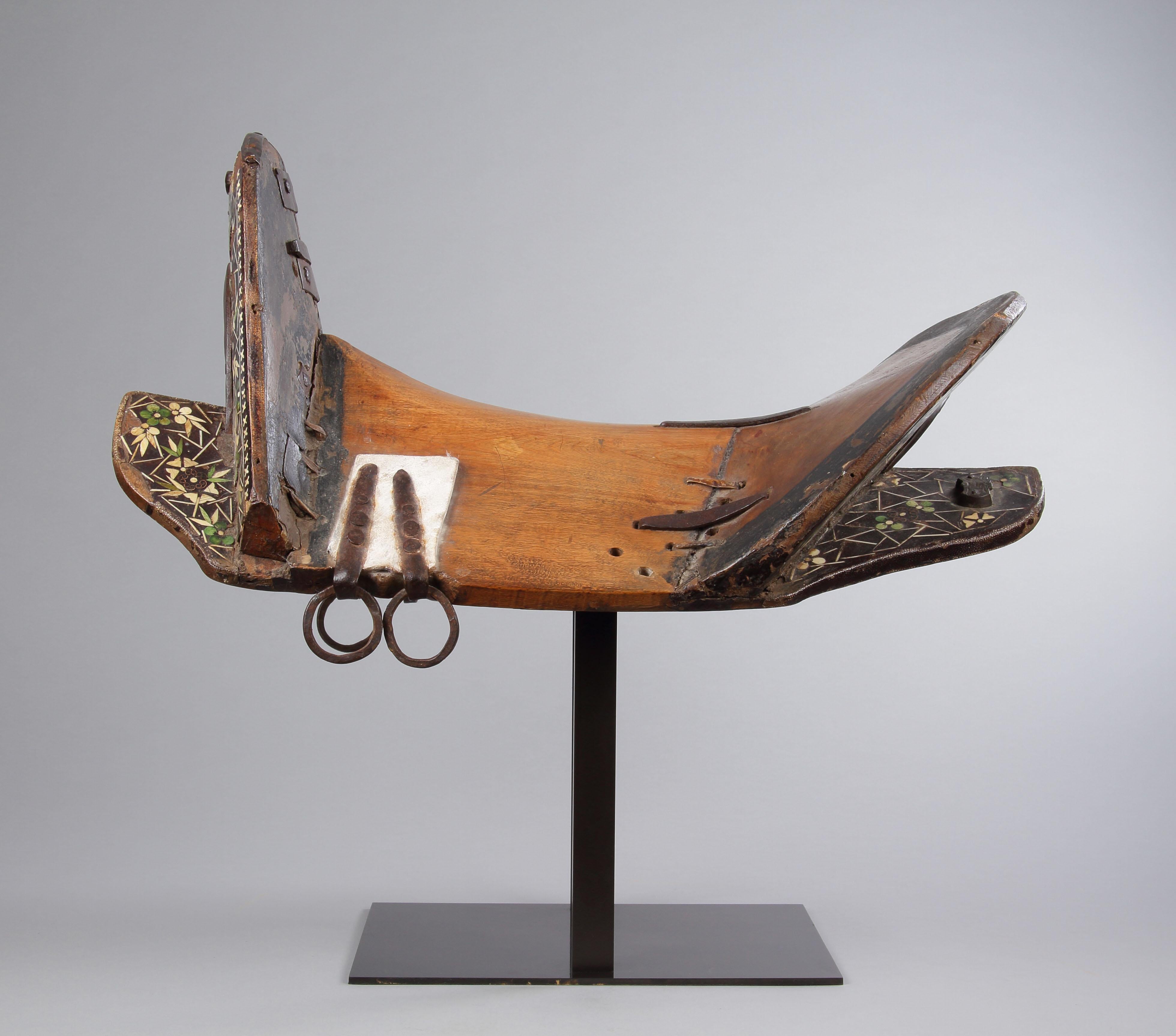 A Rare Western Tibetan Horse Saddle as Used by the Kampa Horsemen 

The Wood Frame Inlaid with Green Stained and Plain Ivory and Copper Wire to Resemble Prunus Blossom the Borders Edged with Shagreen and Copper Strips Red lacquering to the underside