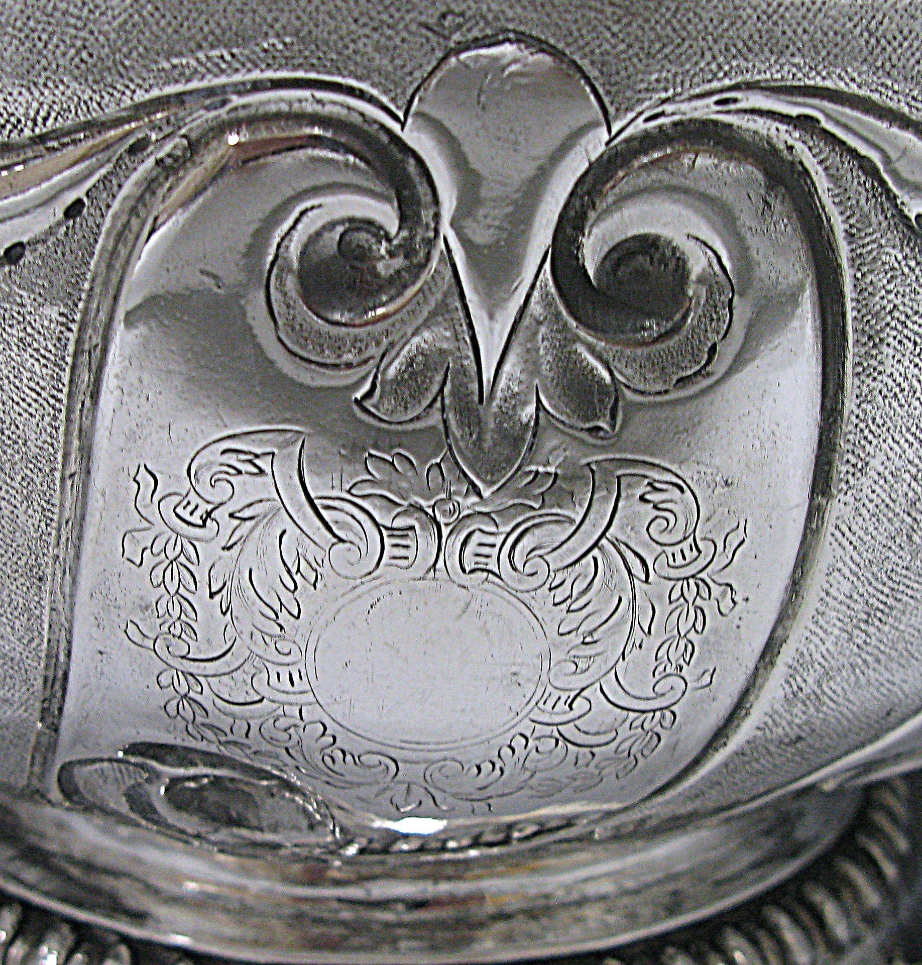 A rare William III antique Britannia silver punch bowl on a raised pedestal gadroon bordered foot. The bowl has a textured background interspersed with inverted fleur-de-lis top blank panels but the front panel does contain a cartouche. The bowl has