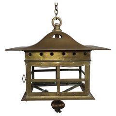 A big Arts and Crafts brass lantern with a domed flaring hat pierced with hearts