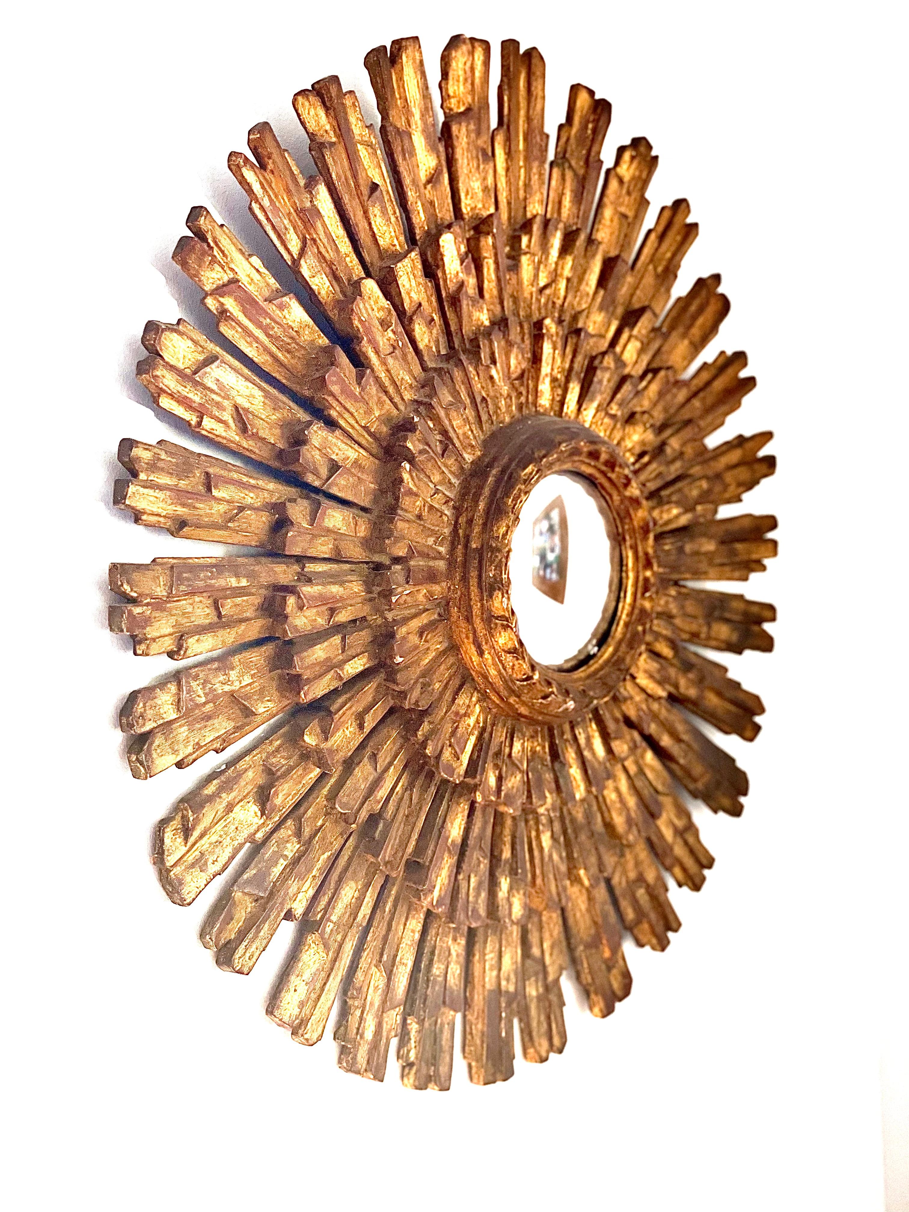 A rather spectacular “Sorcière” giltwood sunburst mirror, with a convex 'witch eye' centre. These mirrors give an startlingly distorted image, and were believed to be imbued with a magical charm, which would ward against negativity while offering