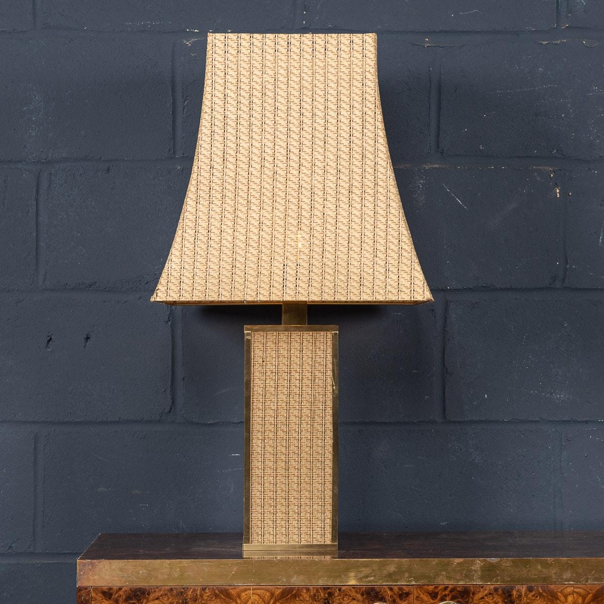 A very unusual and rare table lamp made in Italy in the latter half of the 20th century. Of impressive proportions, this table lamp is complete with its original rattan lamp shade giving a lovely warm glow to any room. The body with a brass