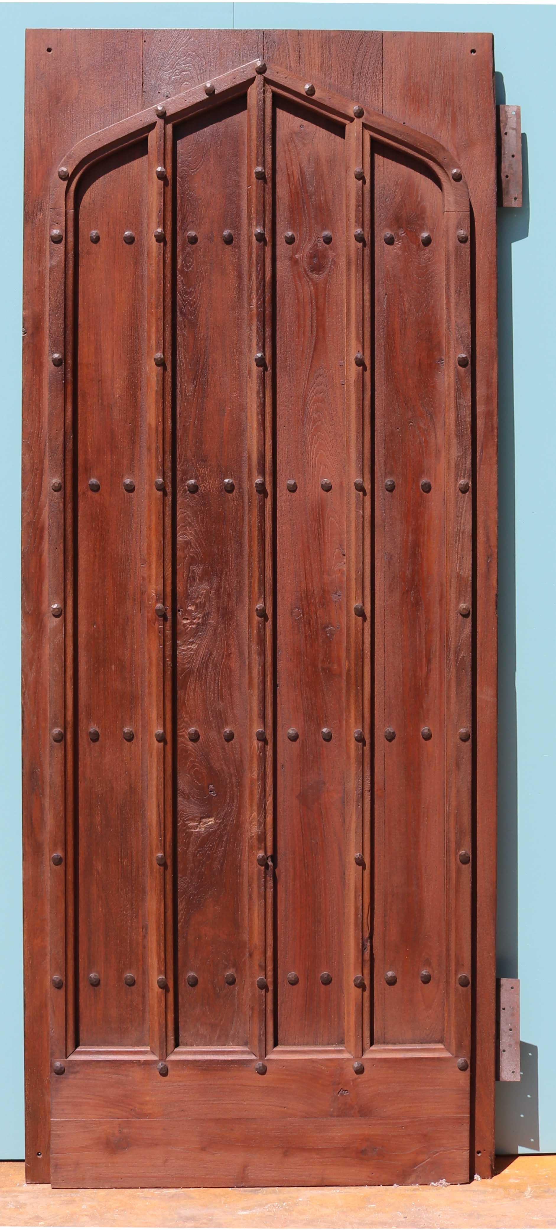 A good quality period style plank door with decorative moldings applied to the front.