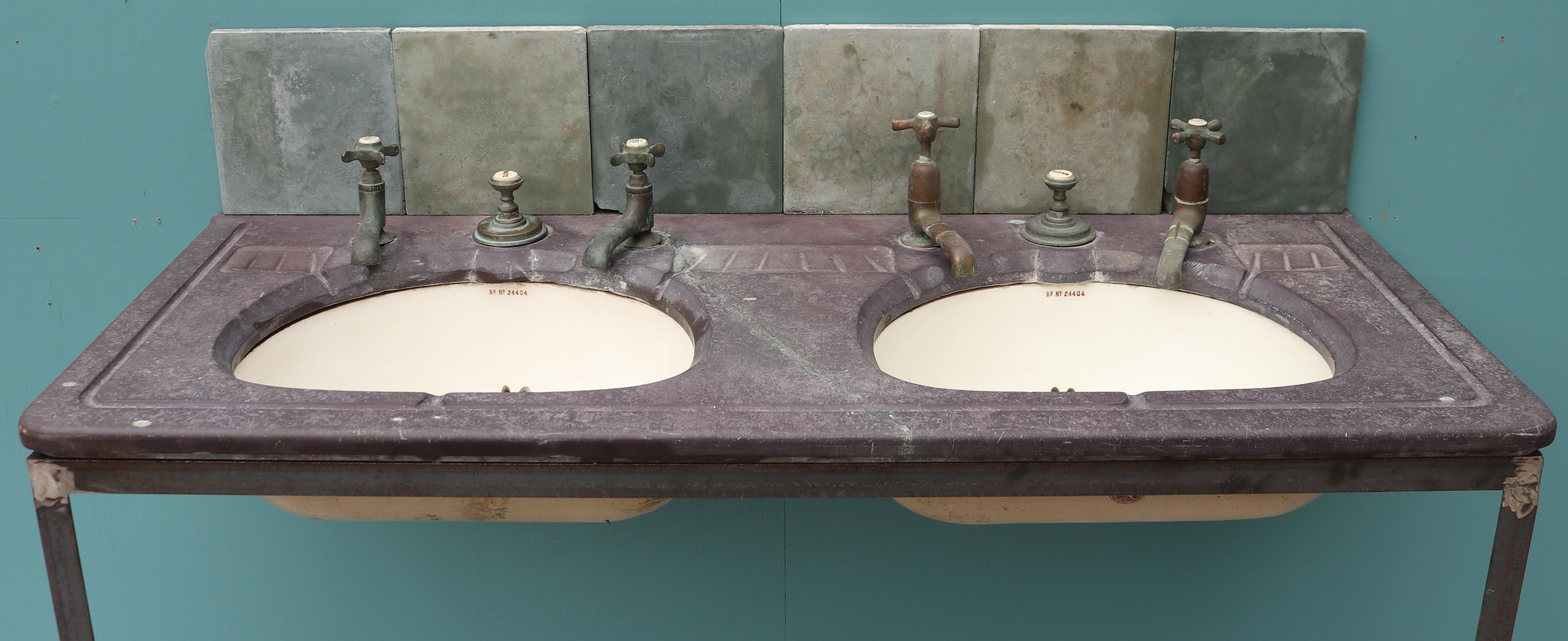 A reclaimed antique double basin or sink by Morrison Ingram & Co. Registered design number 24404. Constructed with a slate top, and under-mounted glazed stoneware basins. Supplied on a modern steel stand and tiles to form a splash-back.
 
We have
