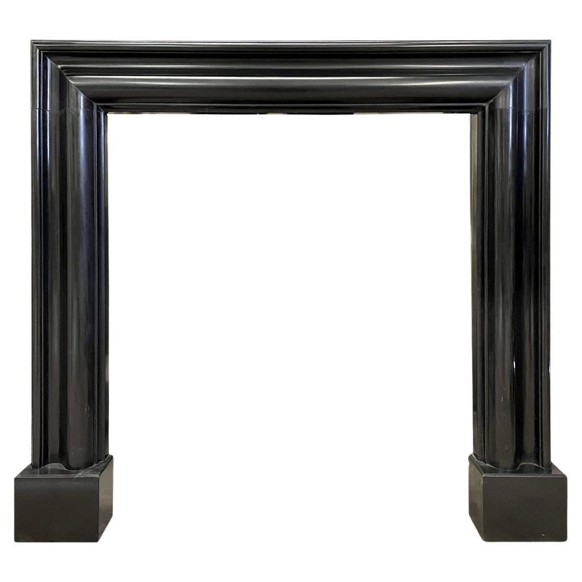 A Reclaimed Black Stone Bolection Fireplace Mantel