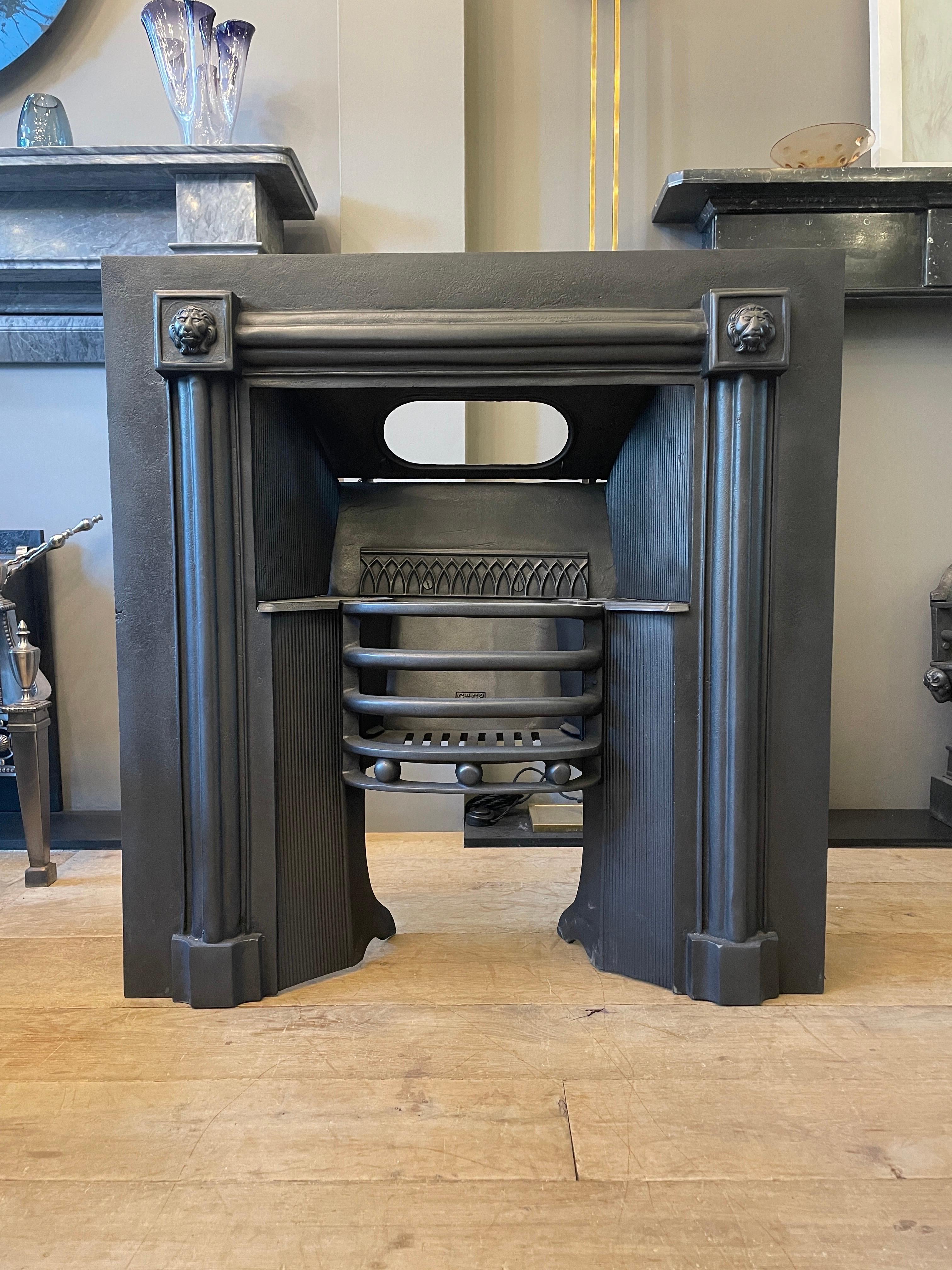 A cast iron register grate/ Fireplace insert in the Regency manner, decorated with Lions masks and inner reeded panels. By Carron and Co 

Damper plate being made 